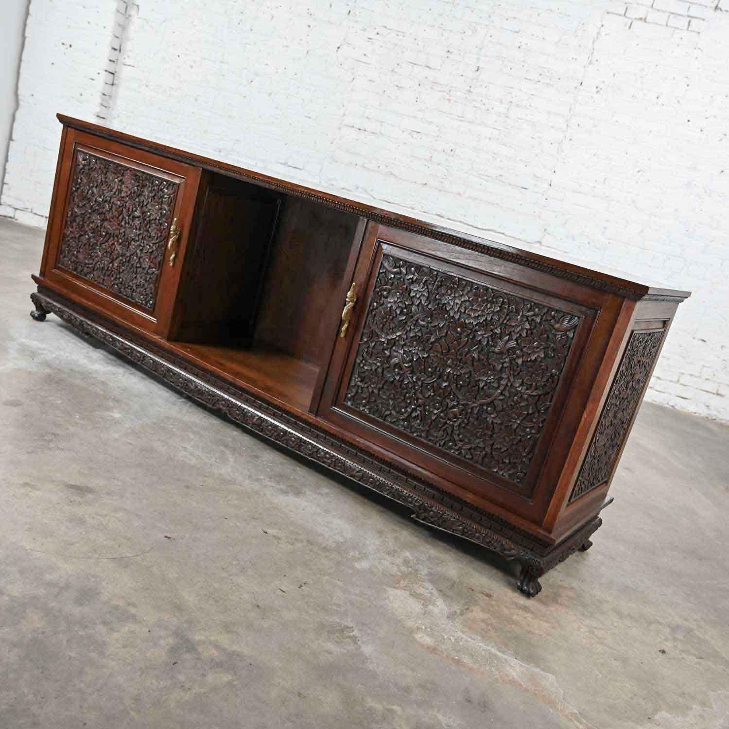 Gorgeous Chinoiserie hand carved Rosewood credenza buffet cabinet from Bangkok, Thailand. Beautiful condition, keeping in mind that this is vintage and not new so will have signs of use and wear. There is a little chip on one of the feet and a nick