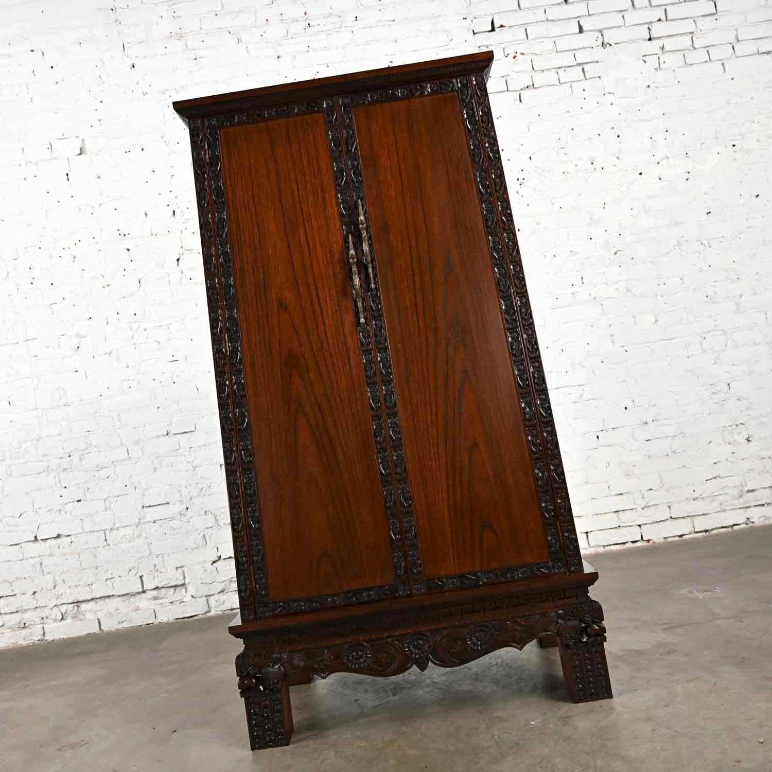 Marvelous vintage Chinoiserie hand carved Rosewood trapezoid cabinet from Bangkok, Thailand. Beautiful condition, keeping in mind that this is vintage and not new so will have signs of use and wear. Has been cleaned and given a fresh coat of Danish