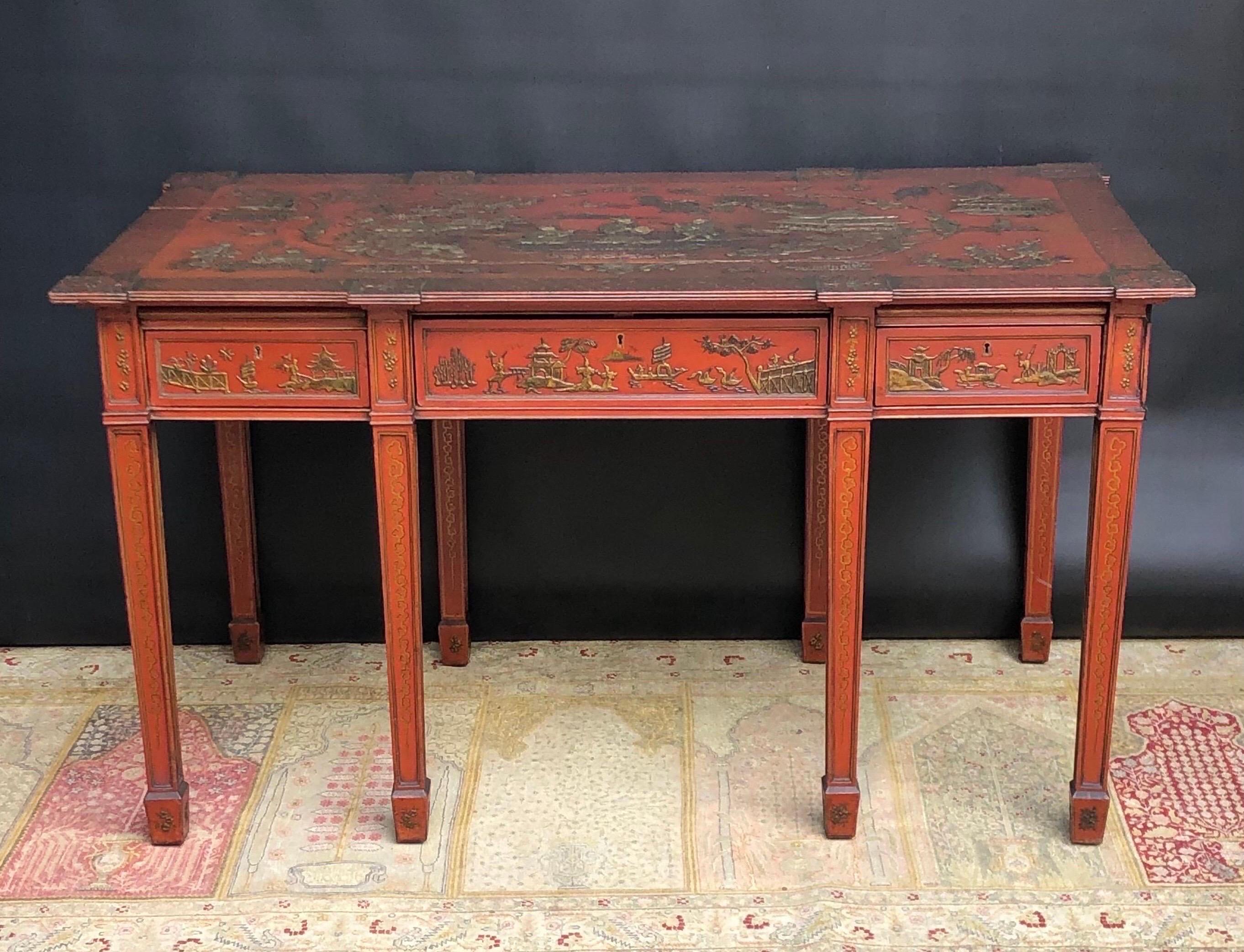 This Elegant English Chinoiserie Partners Writing Desk / Library Table with Exotic Scenes is Japanned in Imperial Red Lacquer. The Chinoiserie Library Table has a rich antique patina and was made in the last quarter of the nineteenth century. The