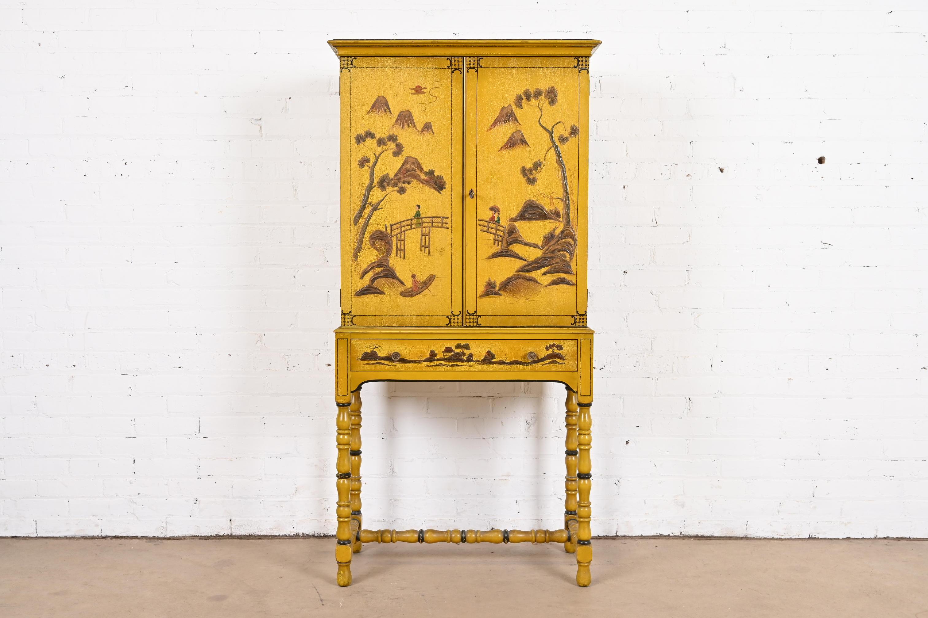 A gorgeous antique Chinoiserie Jacobean style bookcase, dining cabinet, or bar cabinet

In the manner of Baker Furniture

USA, Circa 1920s

Yellow lacquered carved walnut, with hand painted Chinoiserie scenes, and original brass hardware. Cabinet