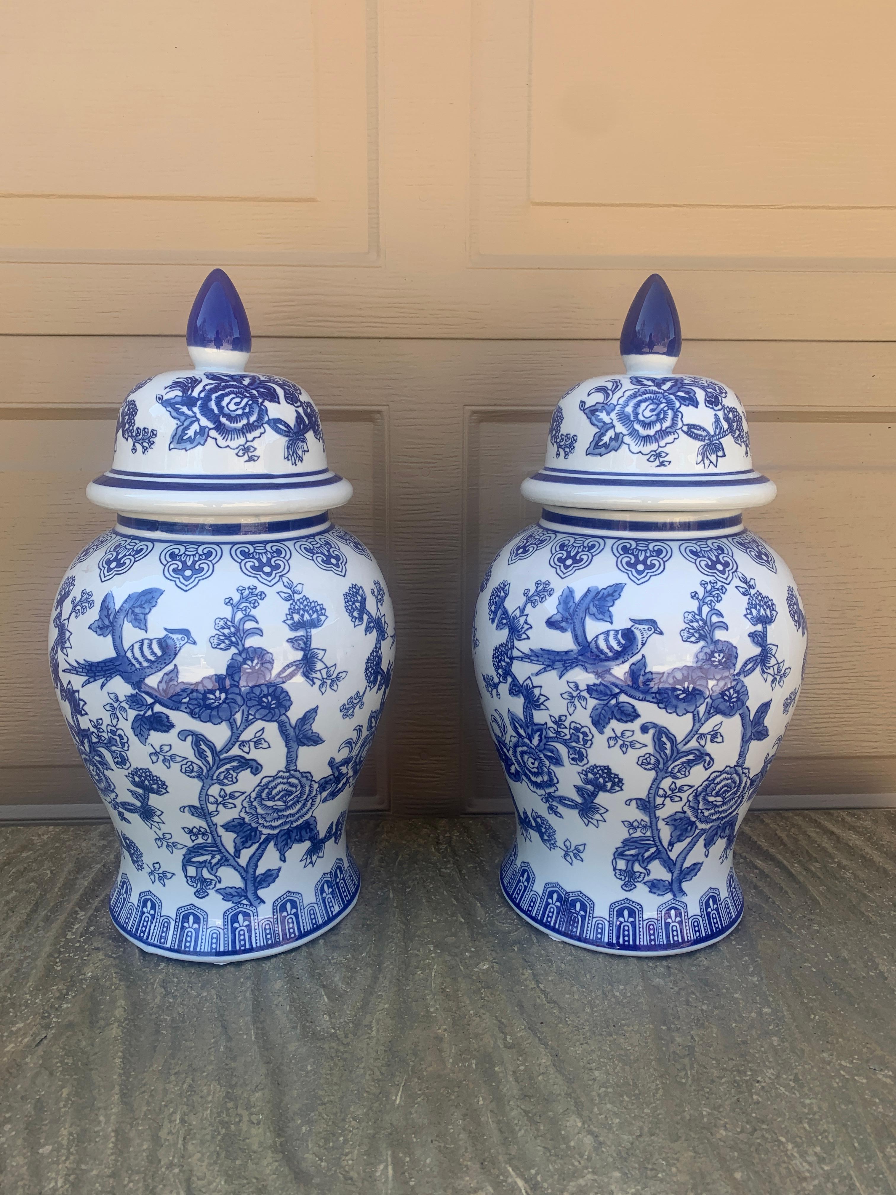 A beautiful pair of large Chinoiserie blue and white porcelain covered ginger jars or temple jars featuring birds and a floral motif

China, Late 20th Century

Measures: 9ʺW × 9ʺD × 18.5ʺH.

Very good vintage condition.