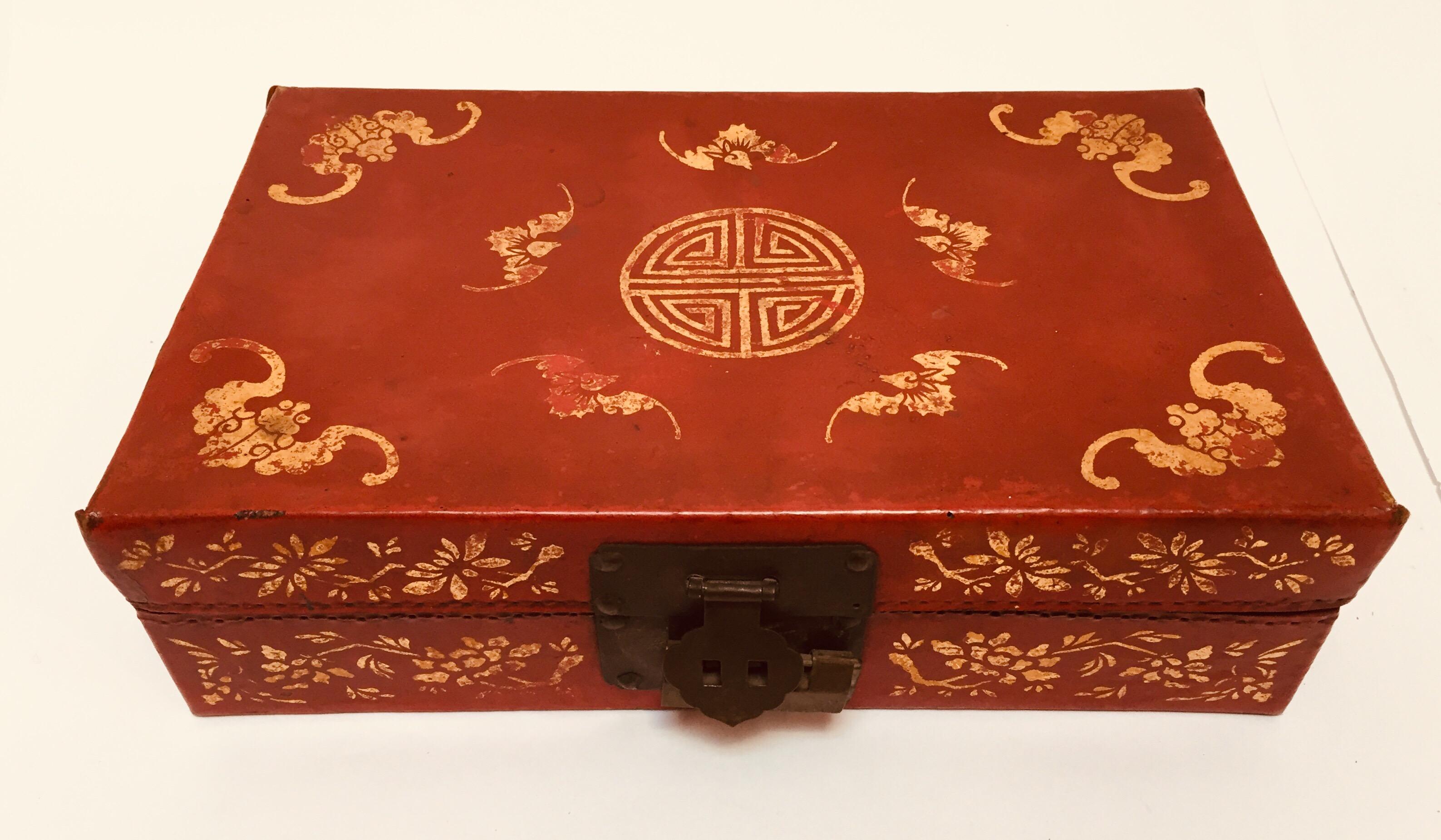 Chinoiserie red leather gilt hand painted oriental traveling box.
This box is in good condition with beautiful crackled appearance in the back where the box open.
Wonderful Chinese box in red, gold painted floral and Chinese writing design on