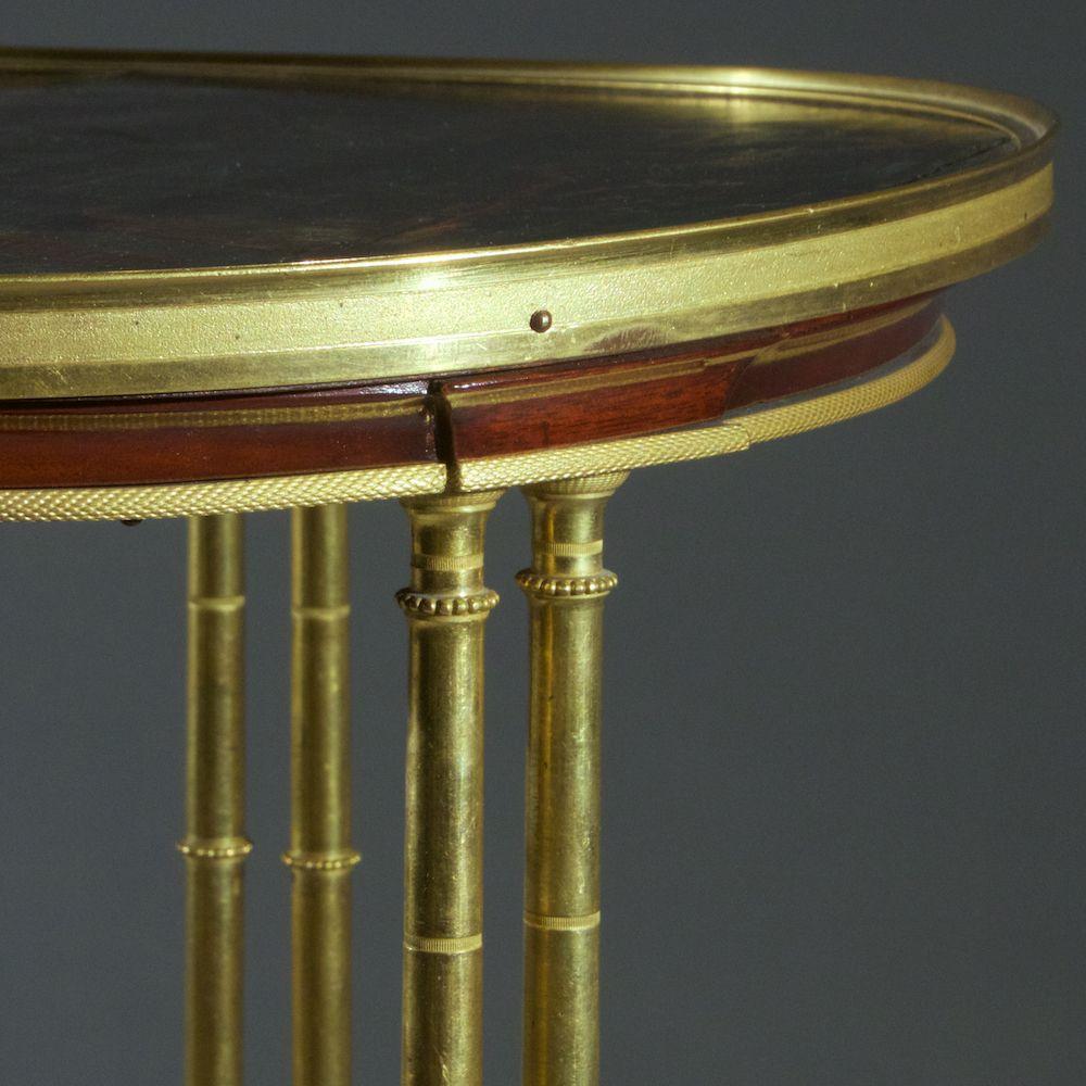A 19th century French chinoiserie Louis XVI style bronze Gueridon sides table with lacquered top after a mode by Adam Weiswiller with bamboo motif.