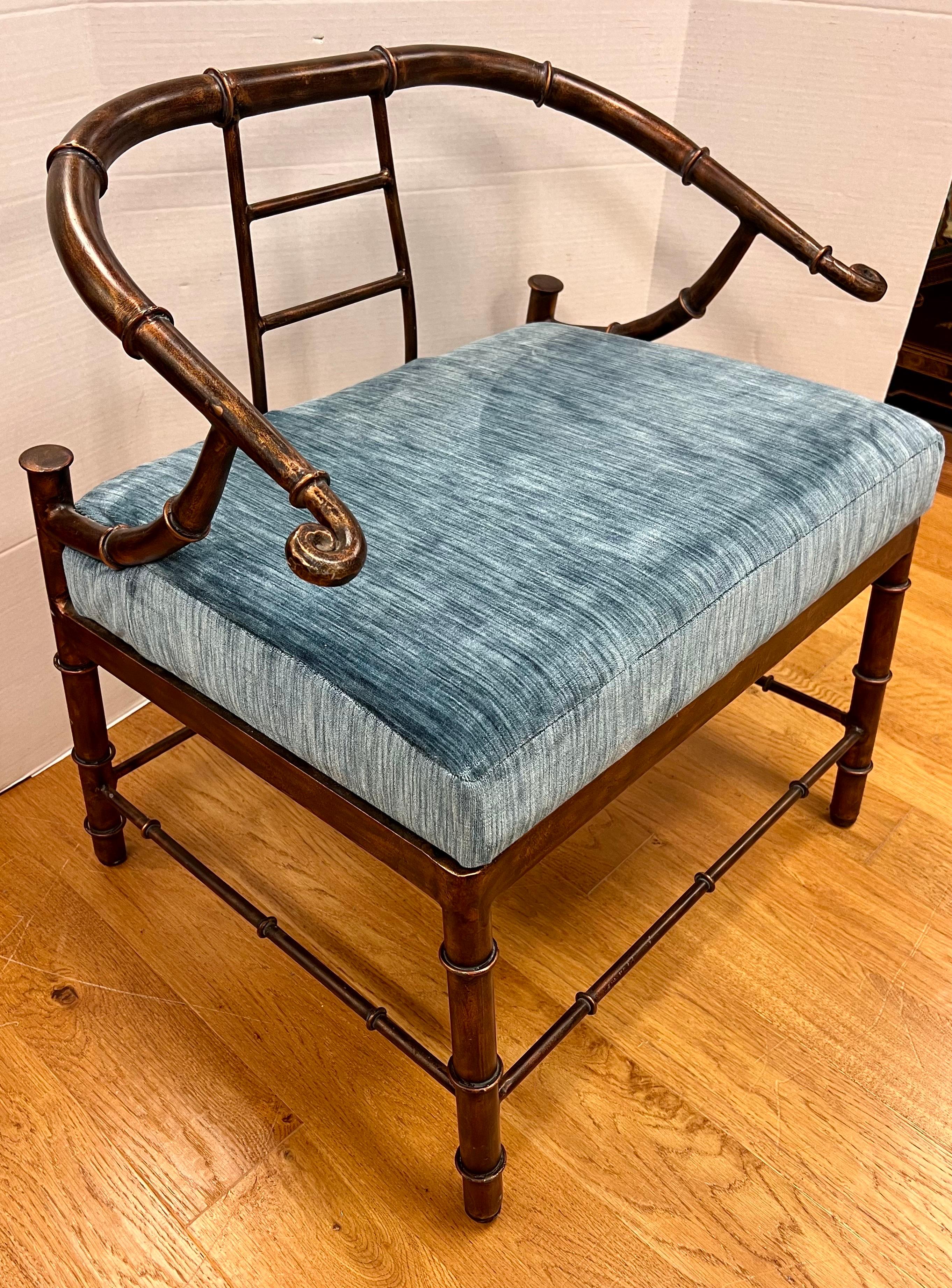 Asian design Mastercraft chinoiserie style lounge chair with bronze finish metal frame and vintage cushion. The curved brass arms and back are faux bamboo, with horizontally scrolled handrests. Legs are set at an angle, square in form, and linear in