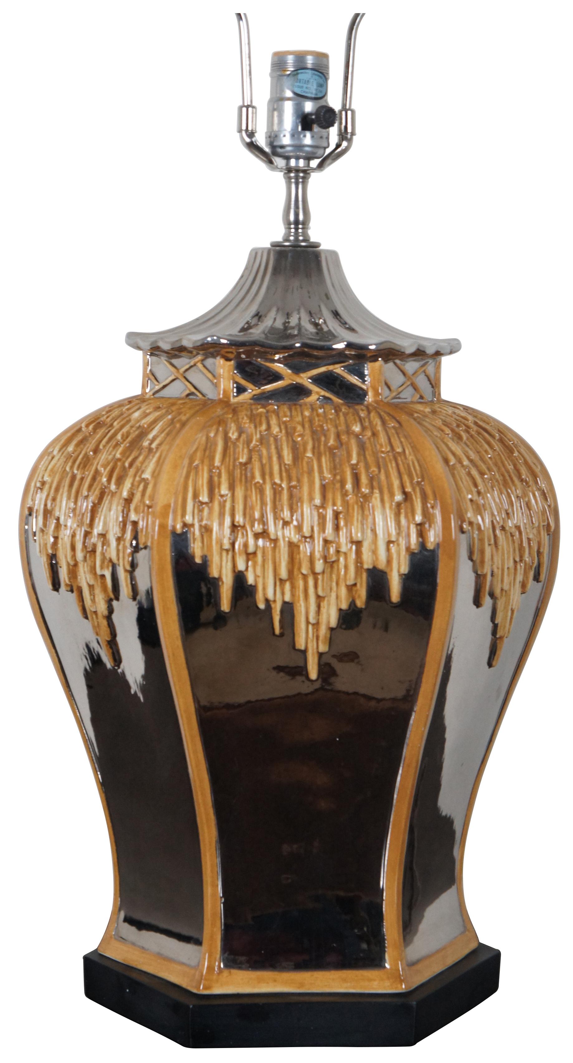 Vintage porcelain table lamp in the shape of a ginger jar styled to resemble a thatched roof pagoda style hut with mirrored sides and roof.

Measures: 13” x 20” / Height to Top of Finial – 28.5” (Diameter x Height).