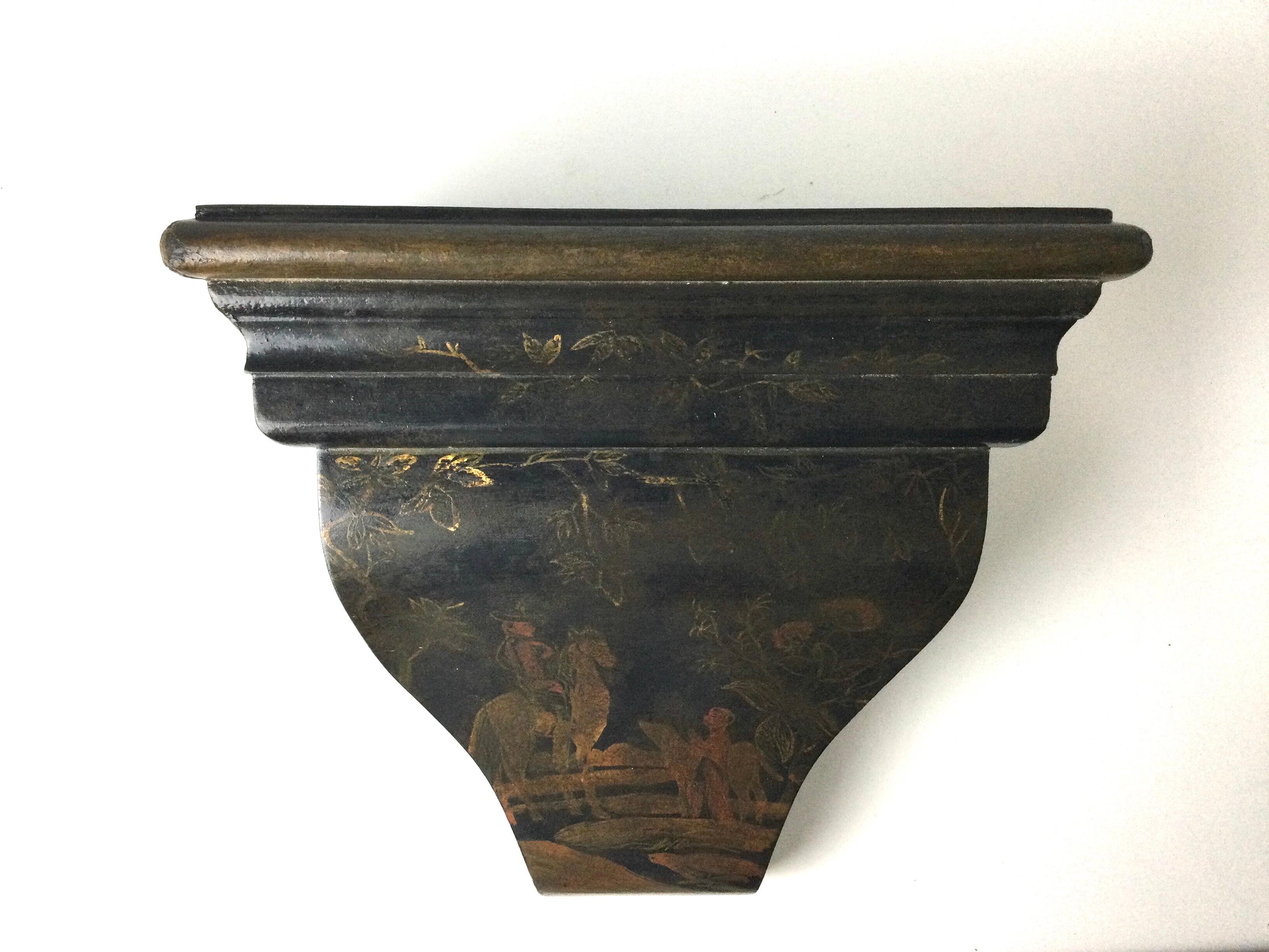 Elegant black and gilt chinoiserie wall shelve. The wood and gesso with hand painted Asian style decoration, 1950's.