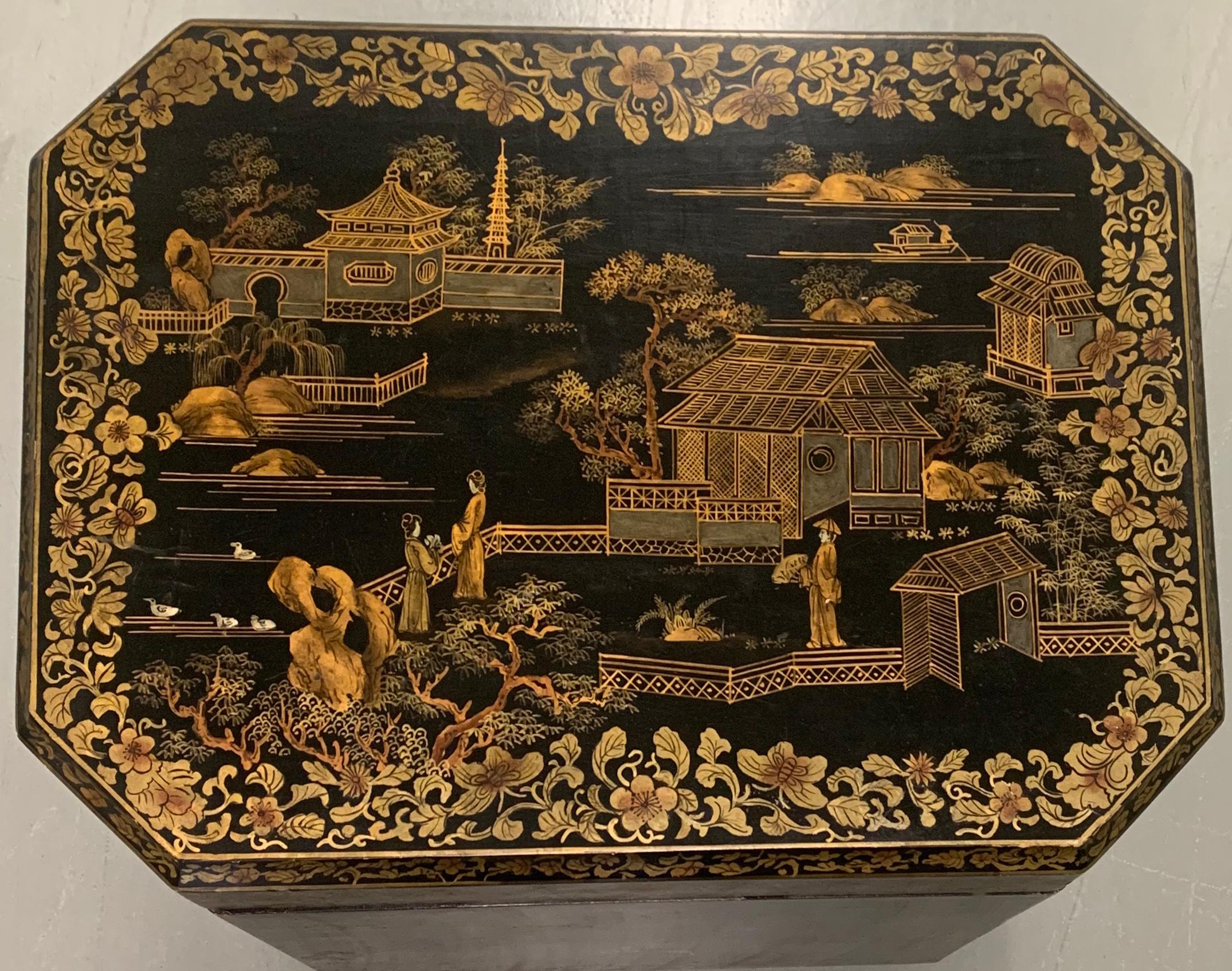 Chinoiserie tea caddy style large side table. Octagonal top. Black painted wood with all over hand painted gold chinoiserie motif. Very solid well built piece. Made in Hong Kong. 
Would also work well as a blanket chest at the foot of a bed or