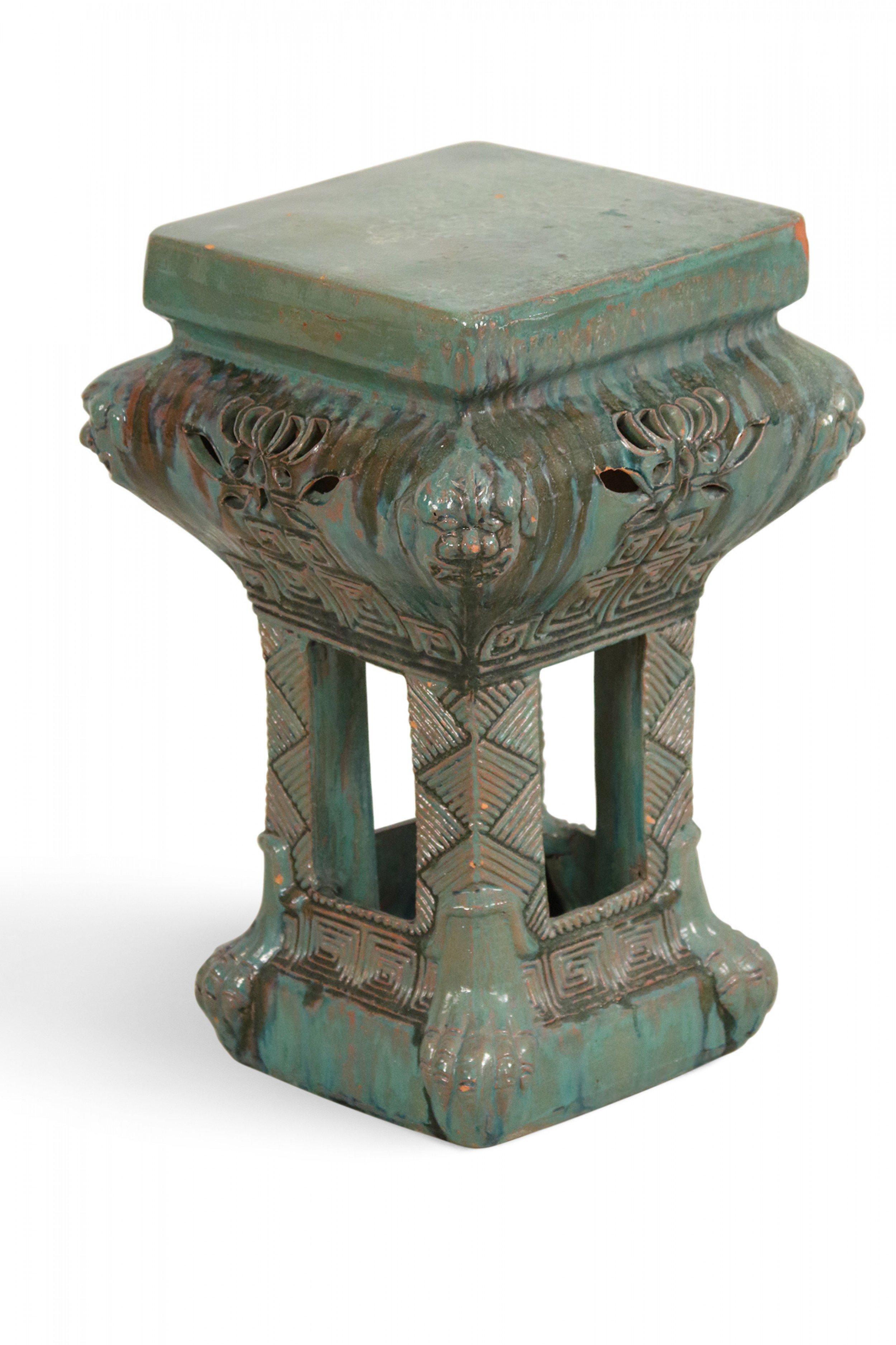 Chinese ceramic garden seat with bowed decorative top on four incised column supports with a square base and top and green and gray glazed finish.