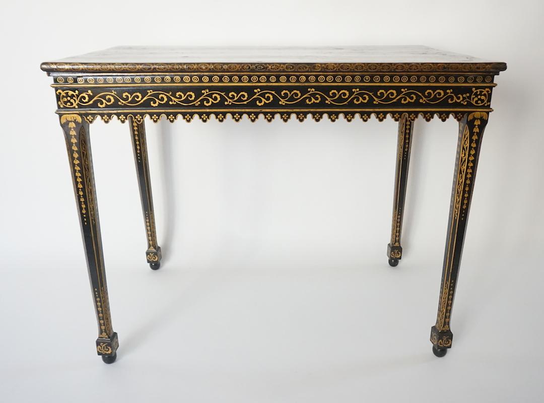 English Aesthetic Movement period side table of rectangular form having 17th-century Japanese parcel-gilt lacquer panel top on painted parcel-gilt base all-over gilt painted chinoiserie motifs. This table exemplifies the European tradition of