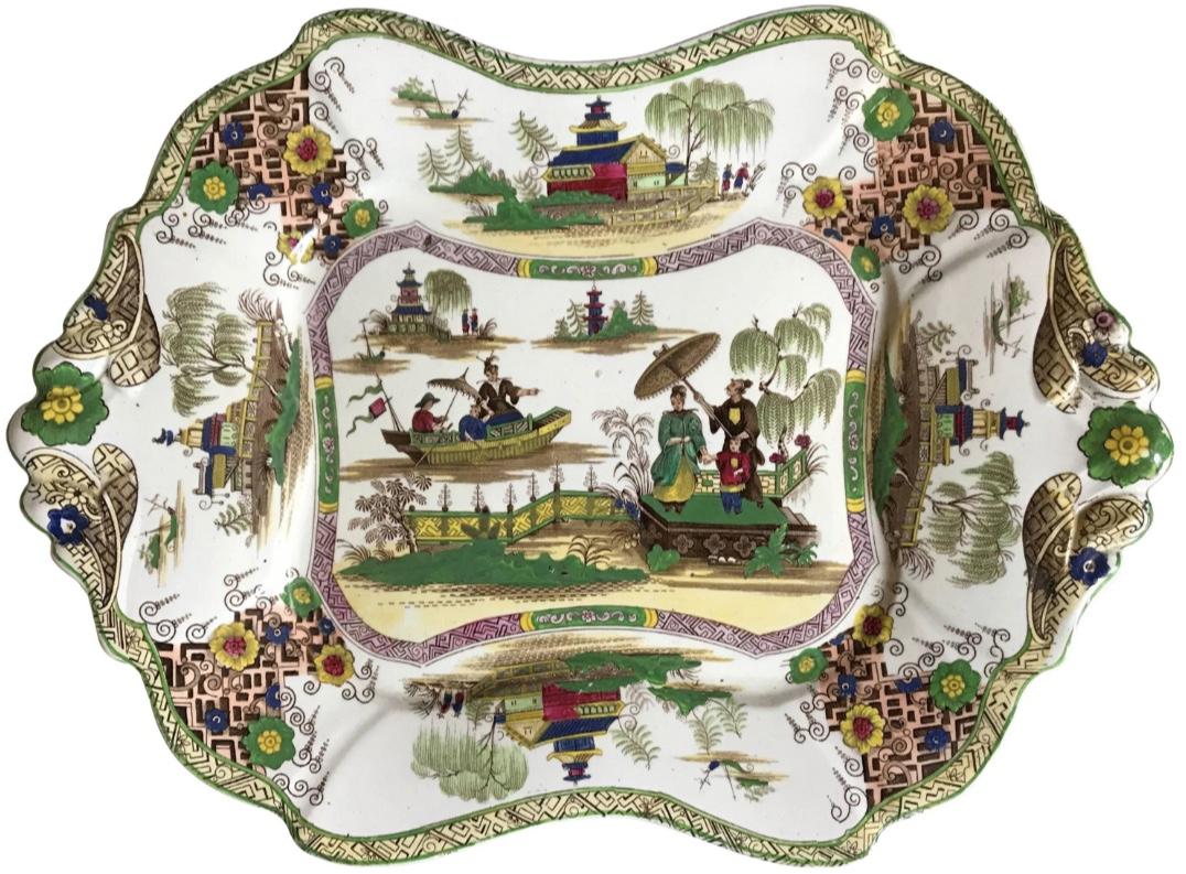 Aesthetic chinoiserie platter.  Aesthetic chinoiserie platter of lobed form with central panel of figures in landscape in greens, blue and yellow with raised flowers and fretwork border. Markings for Napier Imperial Stone, John Ridgway, England,