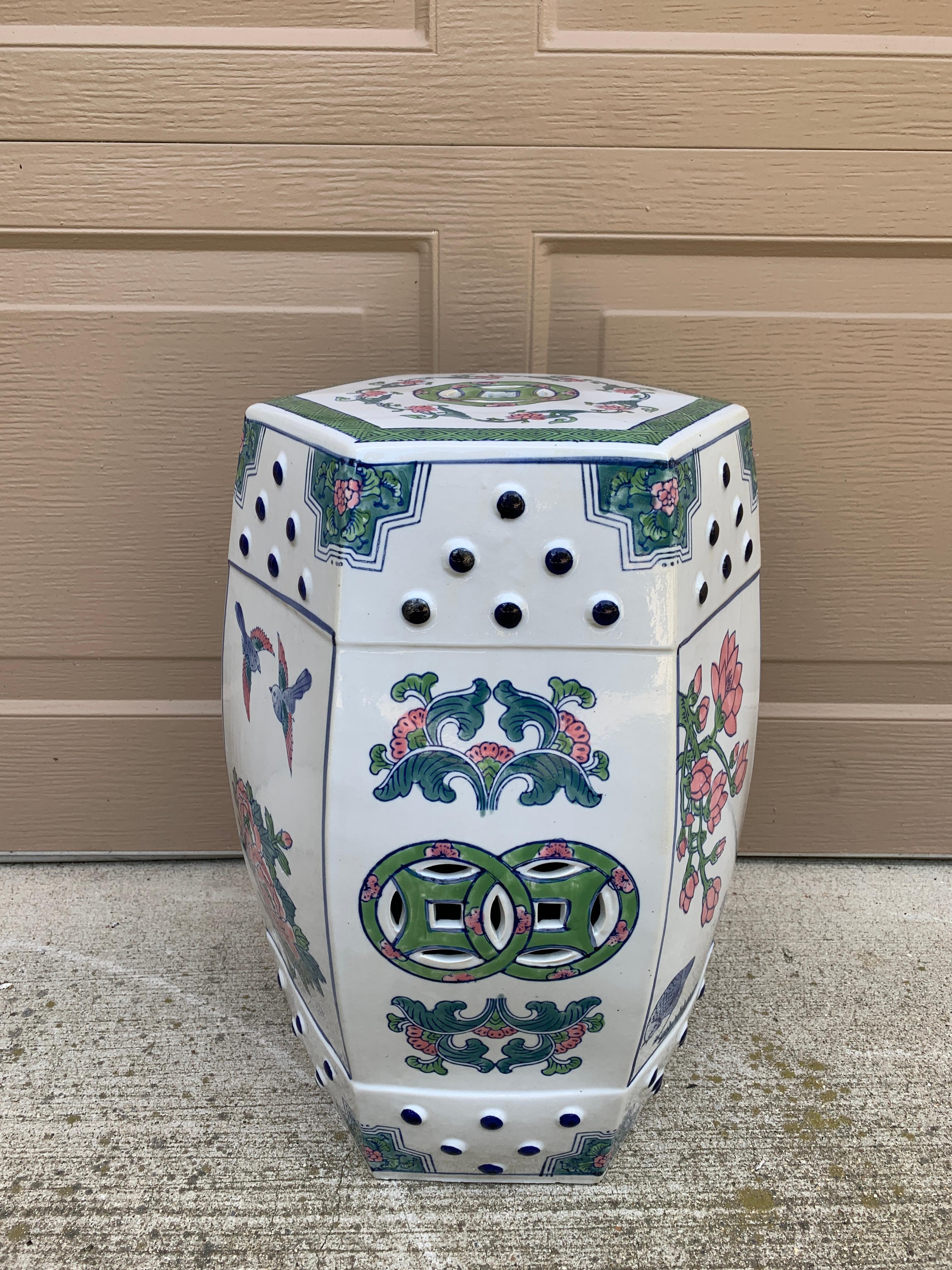 A gorgeous Chinoiserie blue, white, pink, and green porcelain garden stool, plant stand, or small side table featuring birds and flowers

China, Late 20th Century

Measures: 11
