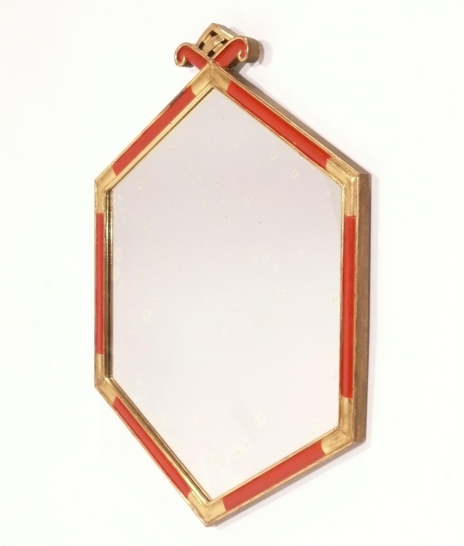 Chinoiserie red lacquer and silver leaf petite mirror, China, circa 1950s. This mirror packs a lot of glamour in a small footprint and would be perfect for a powder room. Retains warm original patina. It measures 23