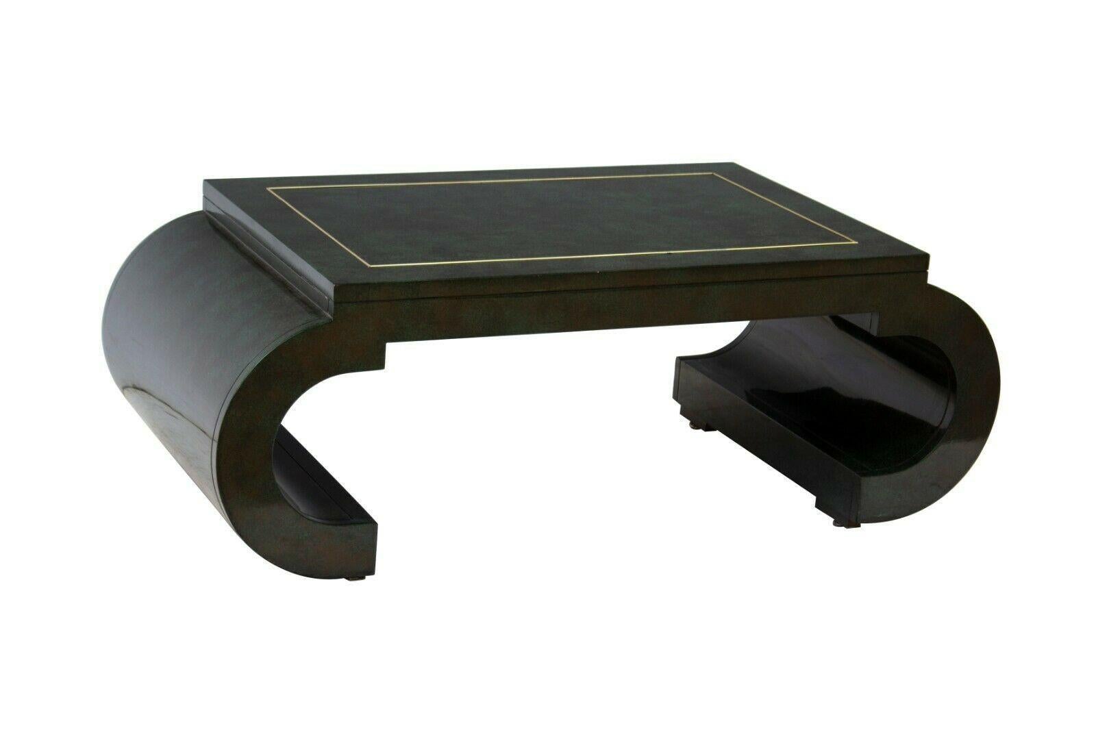 USA, 1980s
 

Scroll coffee table in mottled green lacquer with brass bead trim. Made by Mastercraft / Baker Furniture. Unique deep emerald green lacquer finish, timeless shape. Top surface measures 36