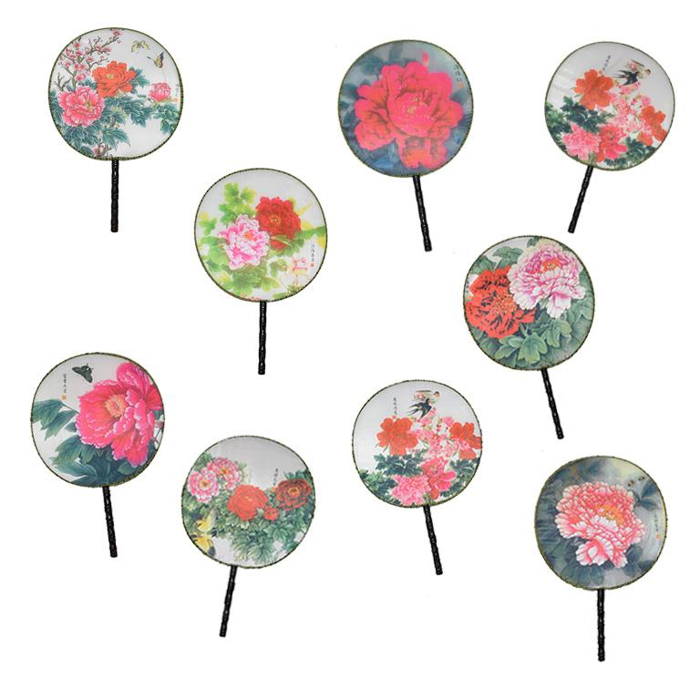 Set of 9 chinoiserie paddle fans. Each fan has an olive green hemmed band sewn on the exterior. The band has a lovely black geometric pattern on it. The center of the fans is printed on silk and in various prints of floral and fauna details. 

The