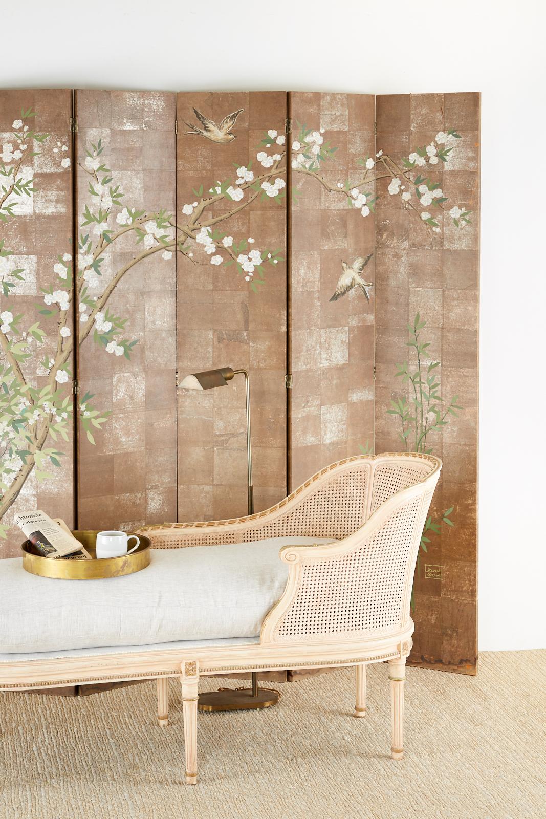Fantastic chinoiserie style six-panel folding screen featuring a blossoming prunus tree with white flowers painted over faded silver leaf squares. Painted by Charles Allyn Gordon (American 1909-1978) in the manner and style of Robert Crowder. Signed