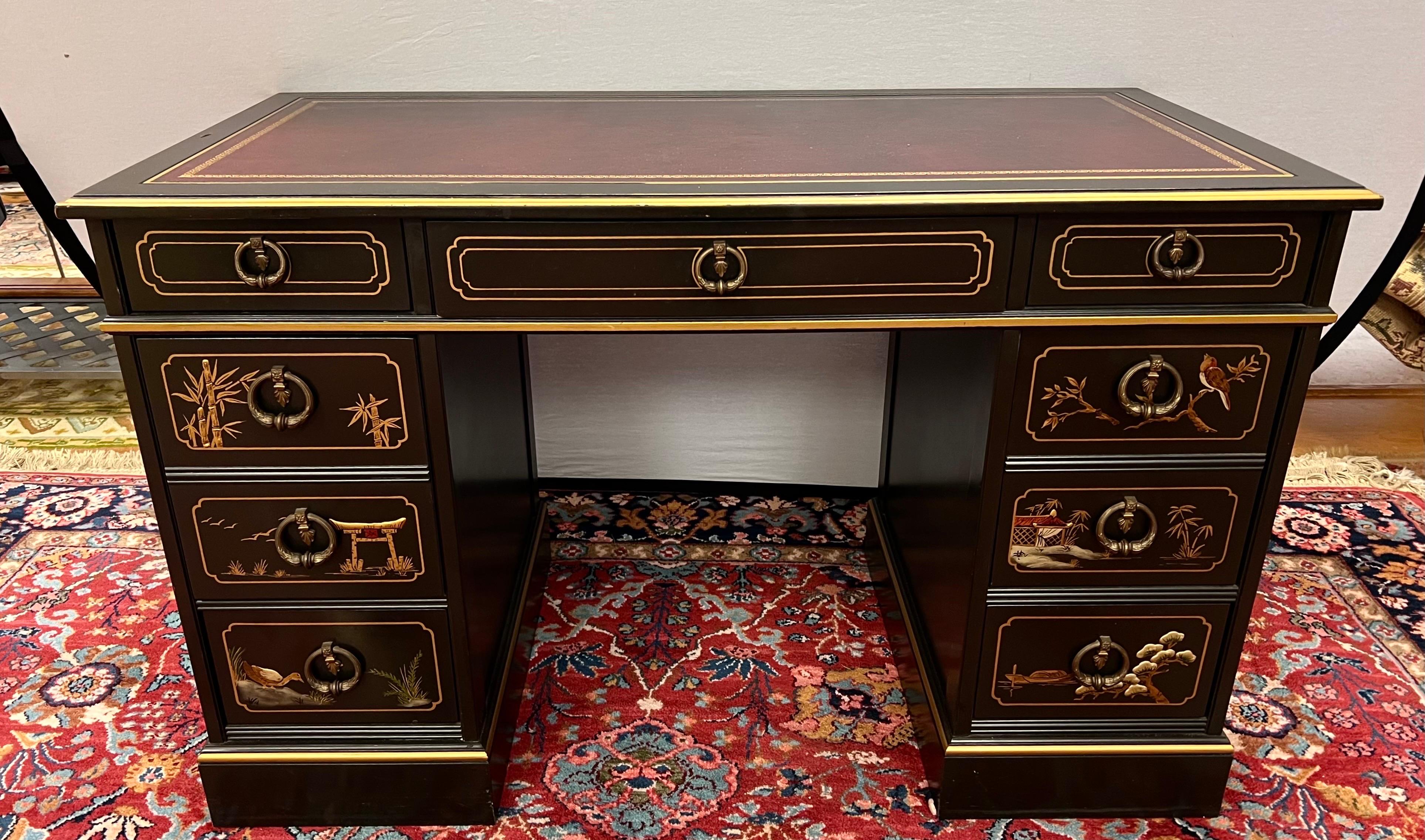 Beautiful chinoiserie black lacquered partners desk. Features a brown leather writing surface and multiple drawers on both sides. Handpainted scenes on the front and sides. Back is finished as well so it can float inside a room.