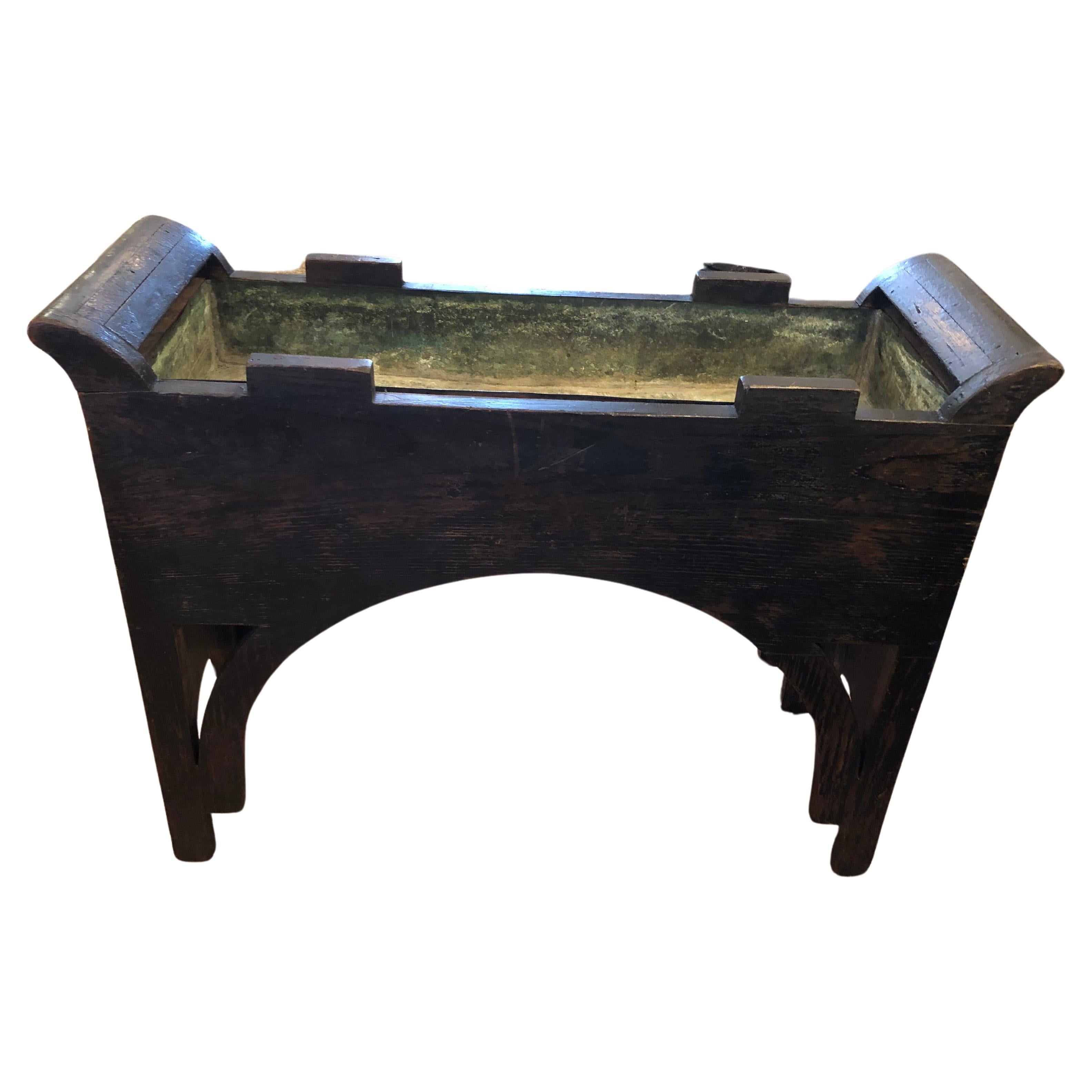 Unusual and character rich chinoiserie ebonized wood rectangular planter having weathered copper liner and wonderful rustic worn patina of figural scenes.
Interior is 4