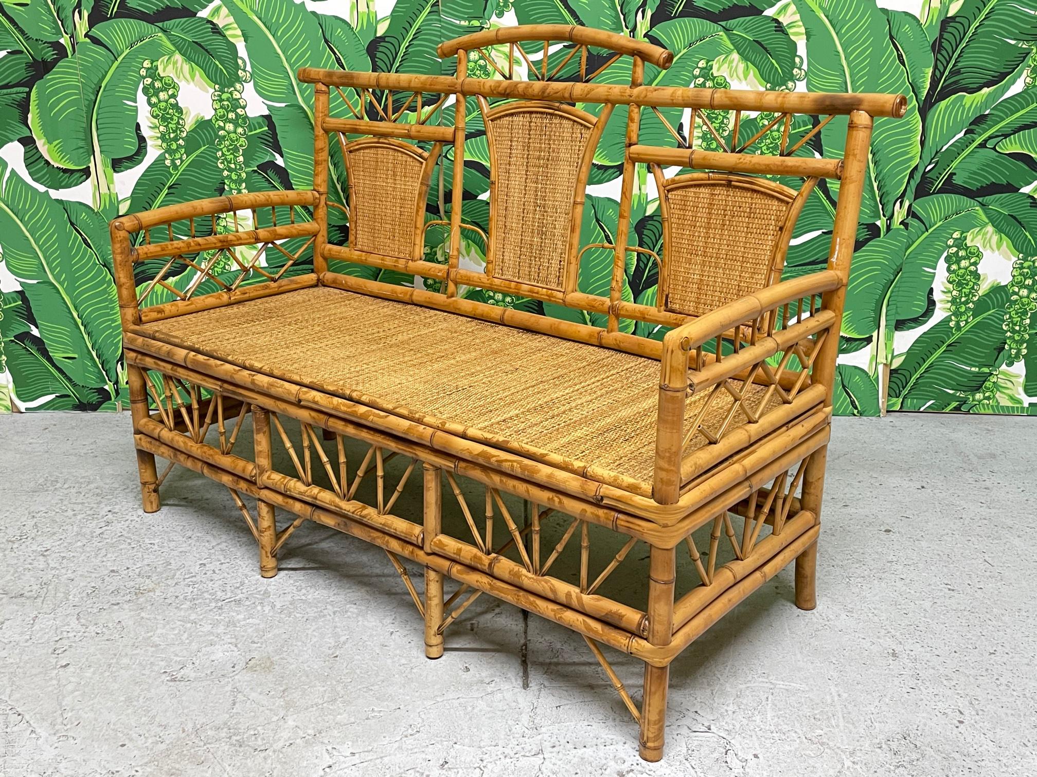 Vintage bamboo bench features an Asian chinoiserie design and woven wicker seat and back inserts. Very good condition with only minor imperfections consistent with age.
  
 