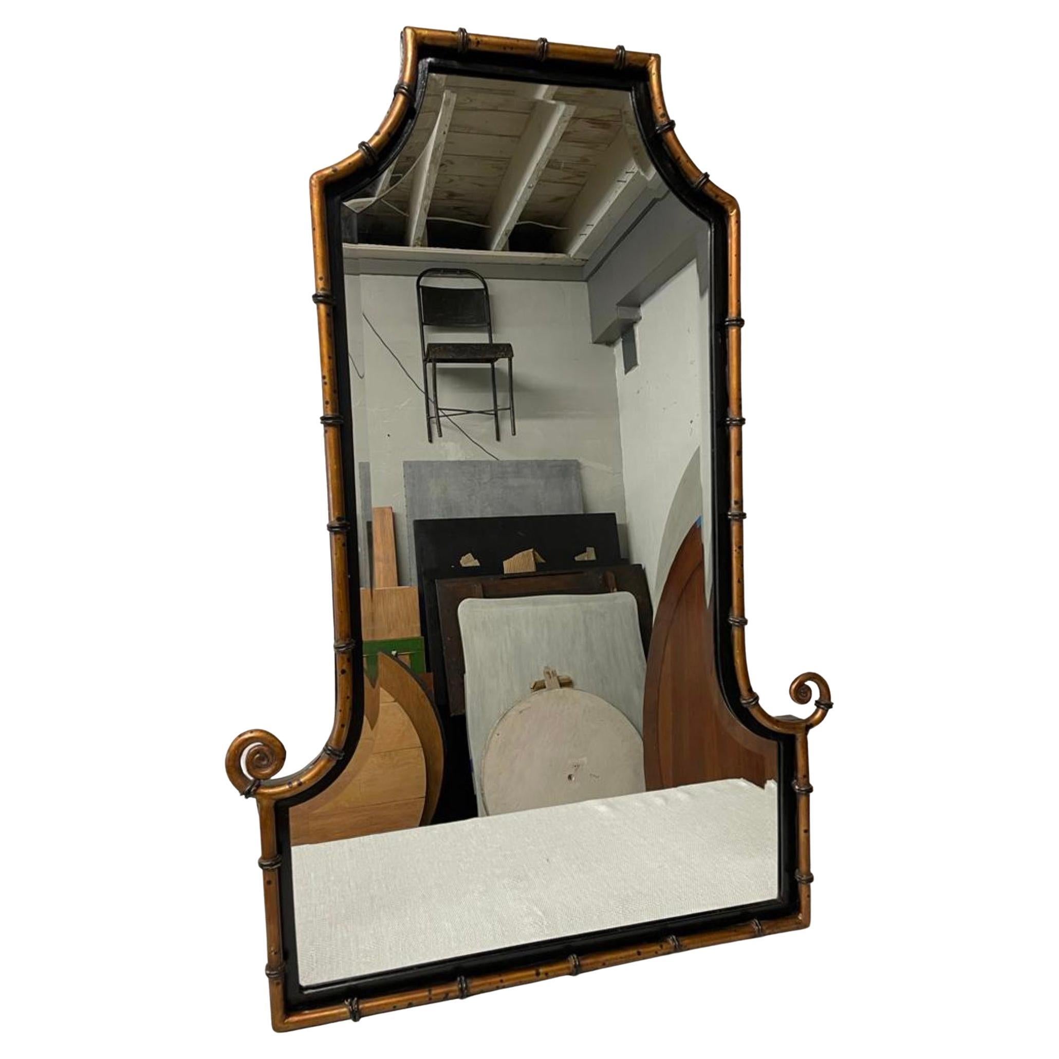 Chinoiserie Style Pagoda Form Faux Bamboo  Mirror with wrought iron painted faux bamboo detail surrounding the center beveled  mirror. 
Wall mirror, mantel mirror, dresser mirror, entry foyer mirror, dresser mirror, hall mirror.