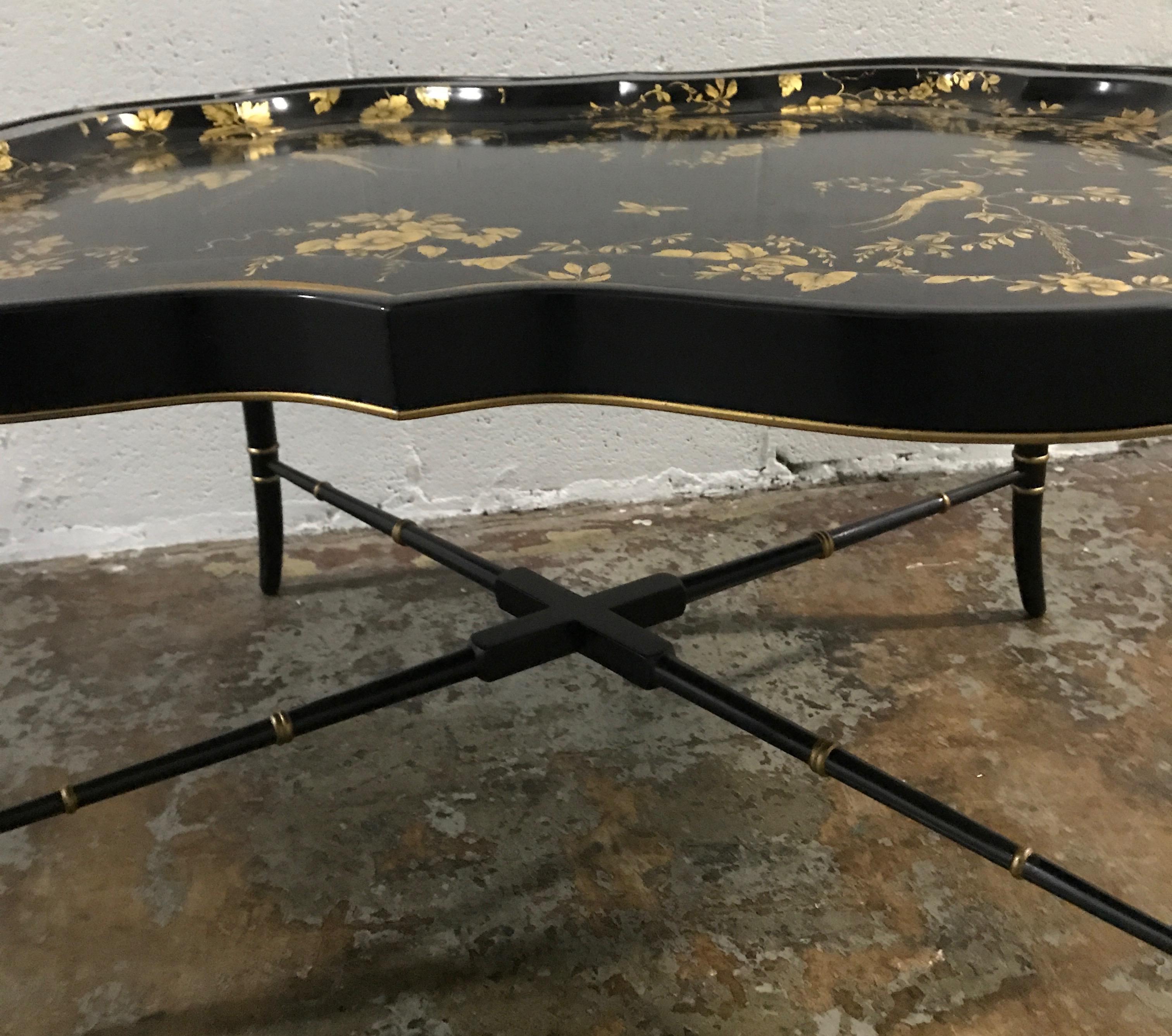 Removable tray top coffee table in black and gold chinoiserie pattern.