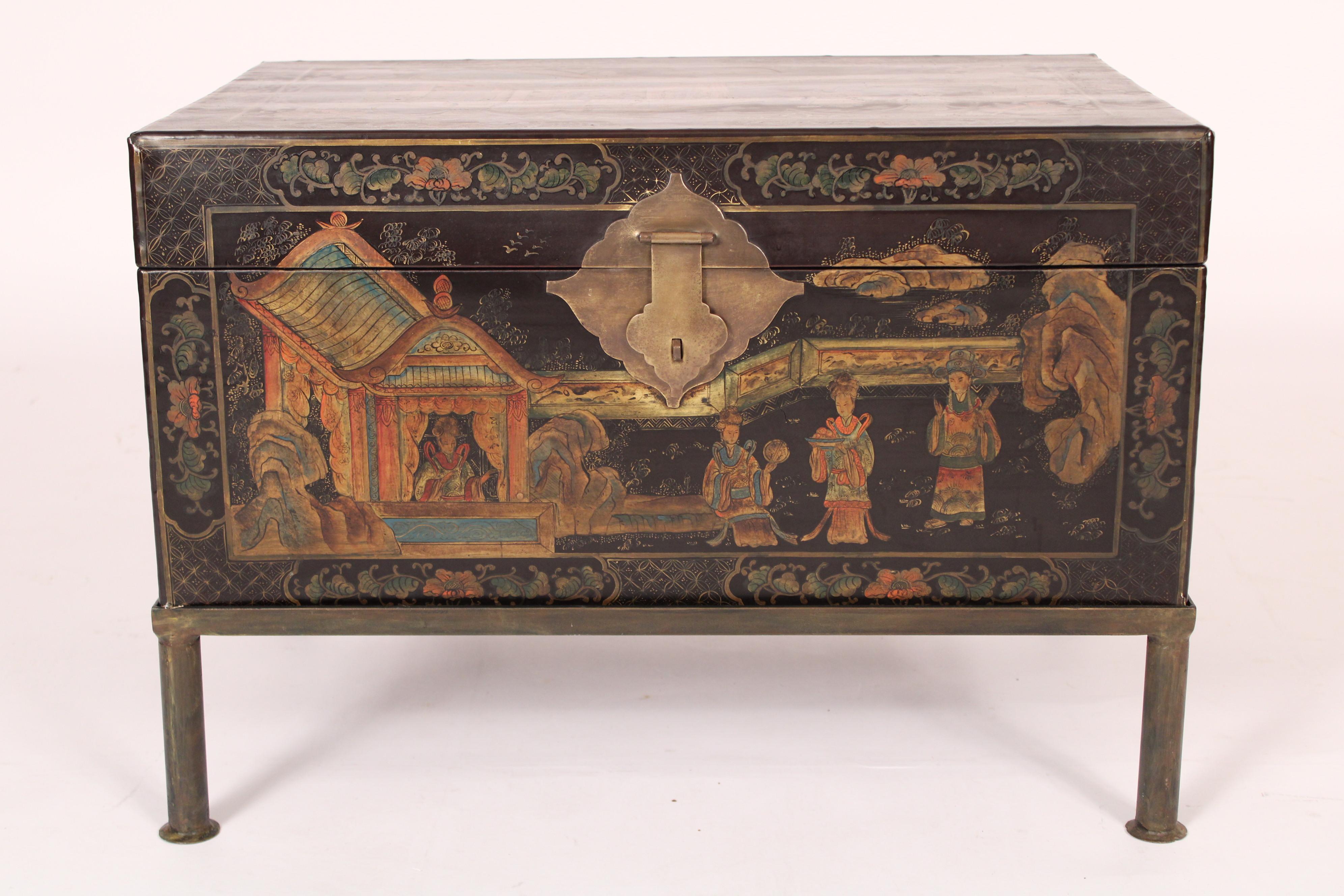 chinoiserie style trunk, circa 1950s on a late 20th century iron base. chinoiserie style decorated wood trunk, with tea house and figures on the front and top, the sides and back decorated with vases and flowers.