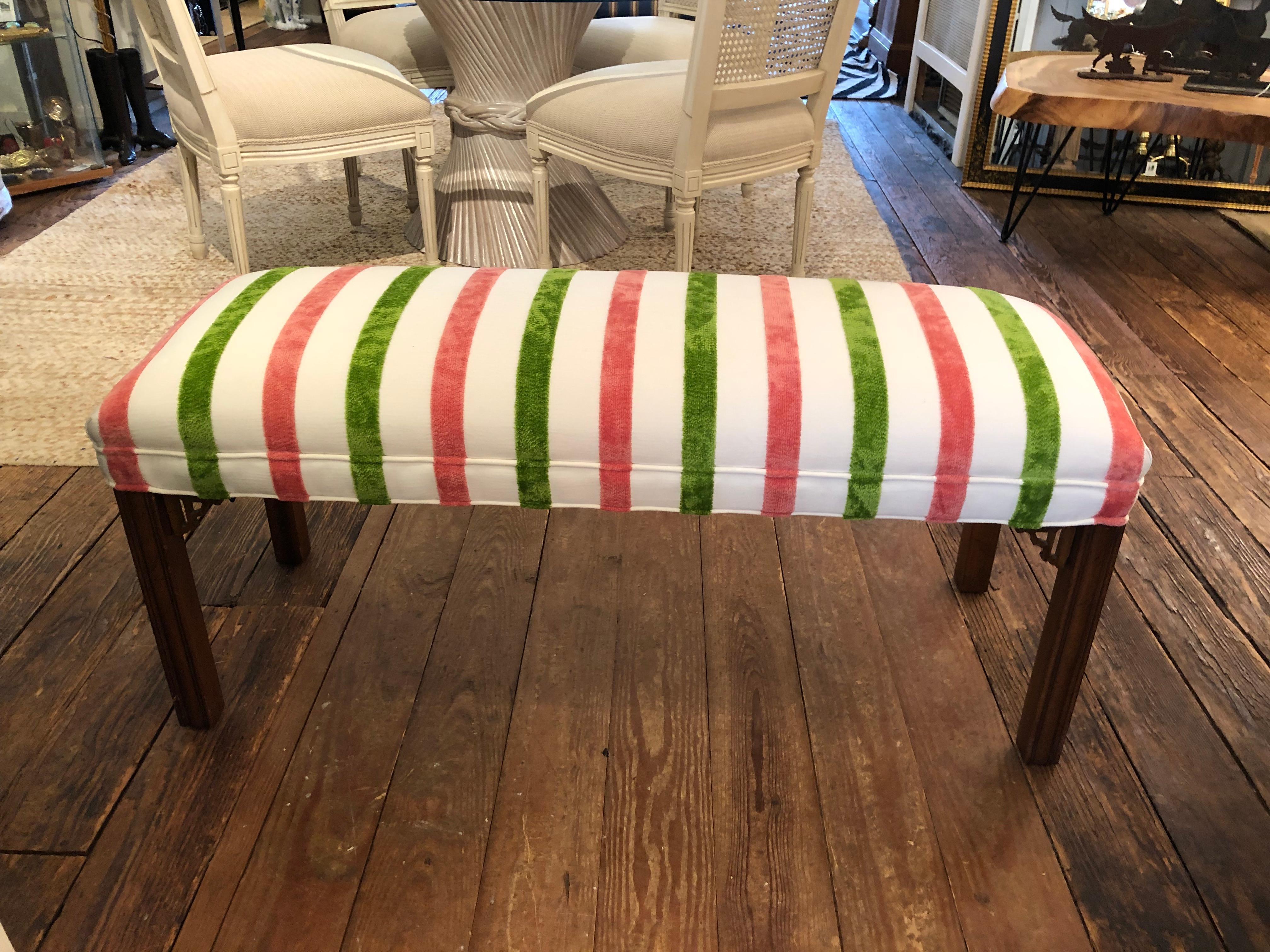 Stylish classic bench having lovely carved wooden legs with classic fretwork detailing at the top of the legs.  The new luxurious upholstered seat is a gorgeous cut velvet with raised pink and green stripes against cream background.  