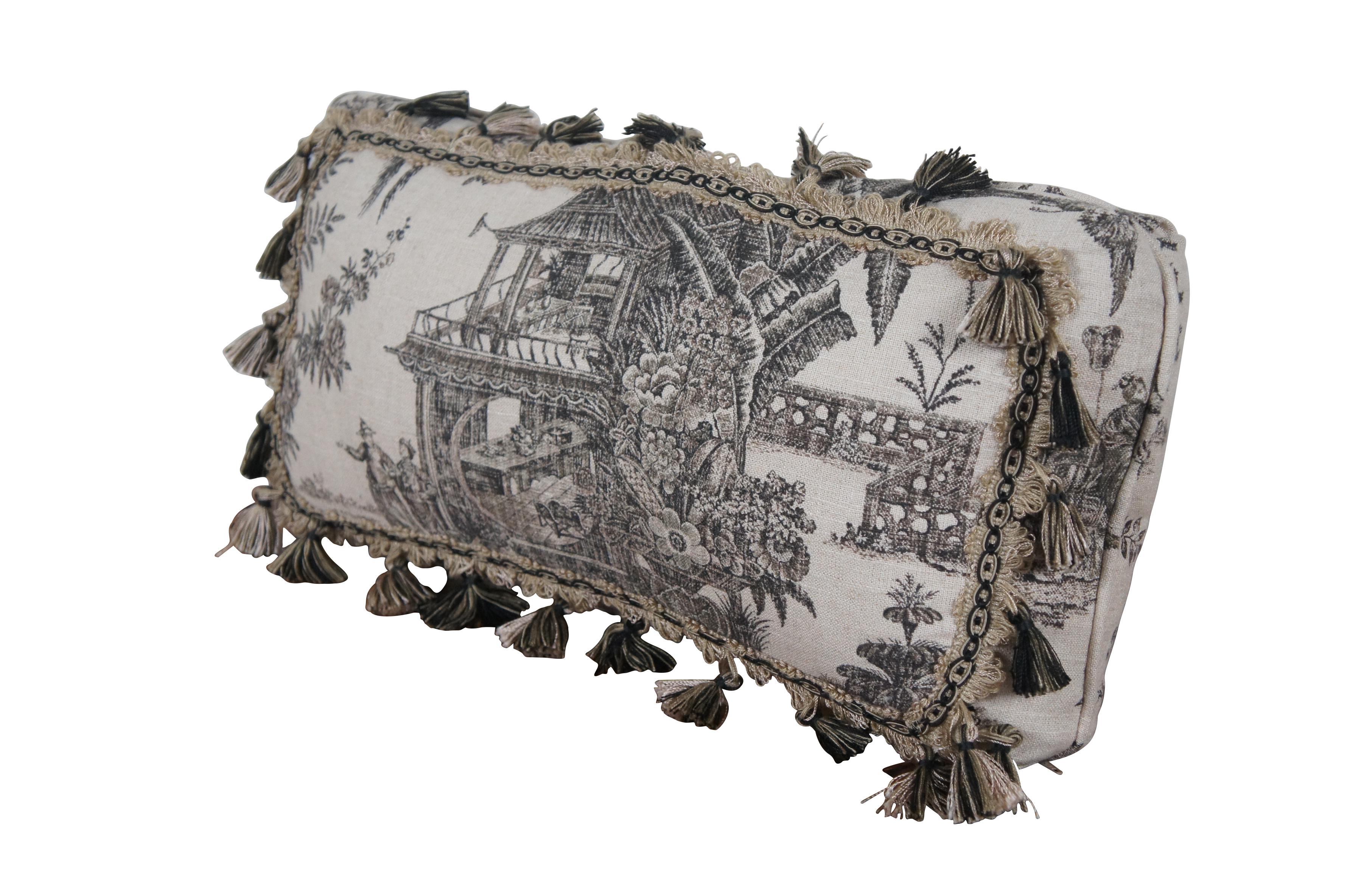 Late 20th century rectangular lumbar / throw pillow, featuring a black and white Chinoiserie toile style print on linen of a garden landscape with pagoda and geisha figures, bordered with cream and black braided trim and tassels. Zipper closure.