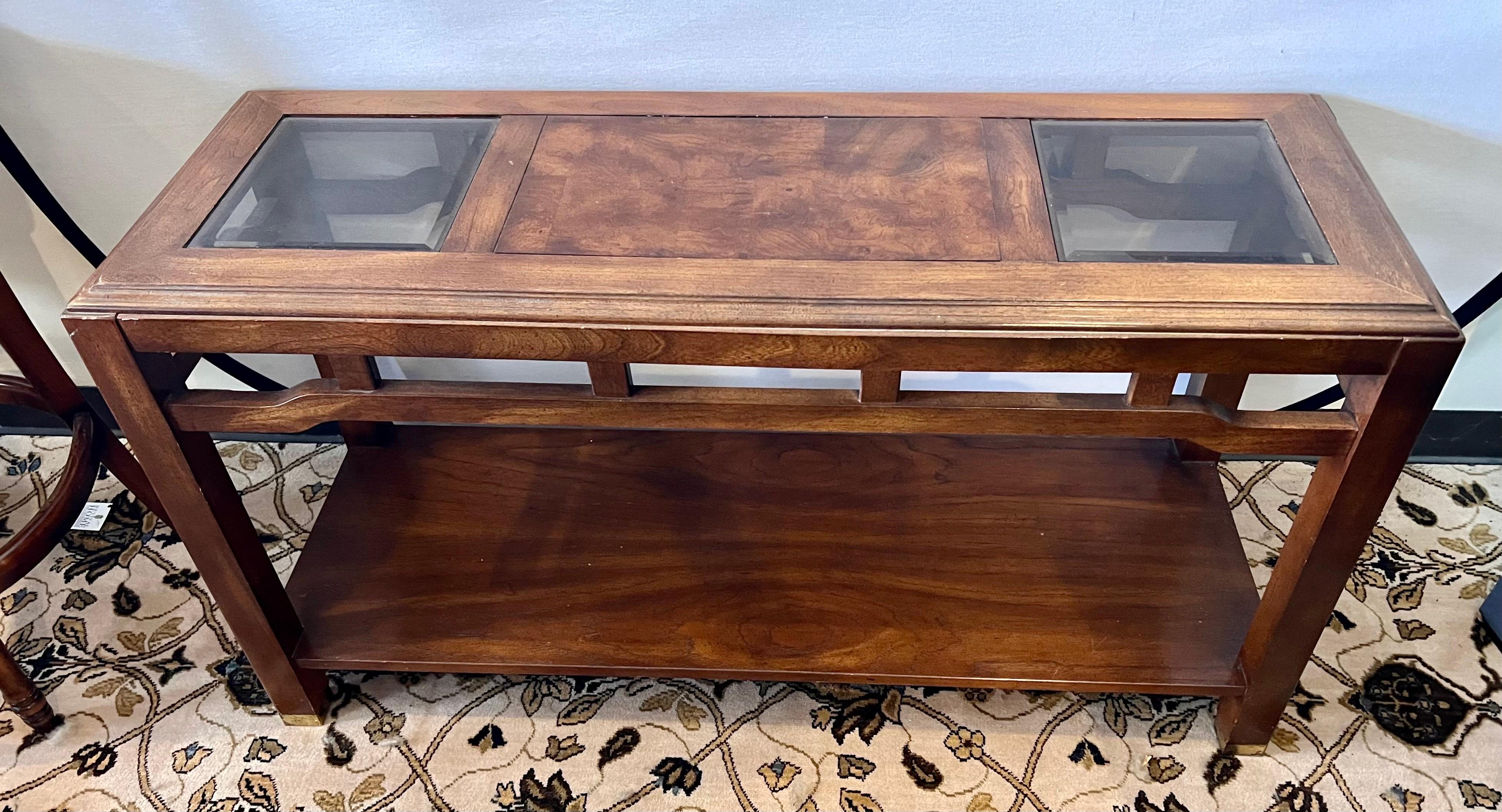 Chinoiserie style two tiered console table with glass inserts on top.  Has brass trim on four feet.  Perfect for foyer or as a sofa table.