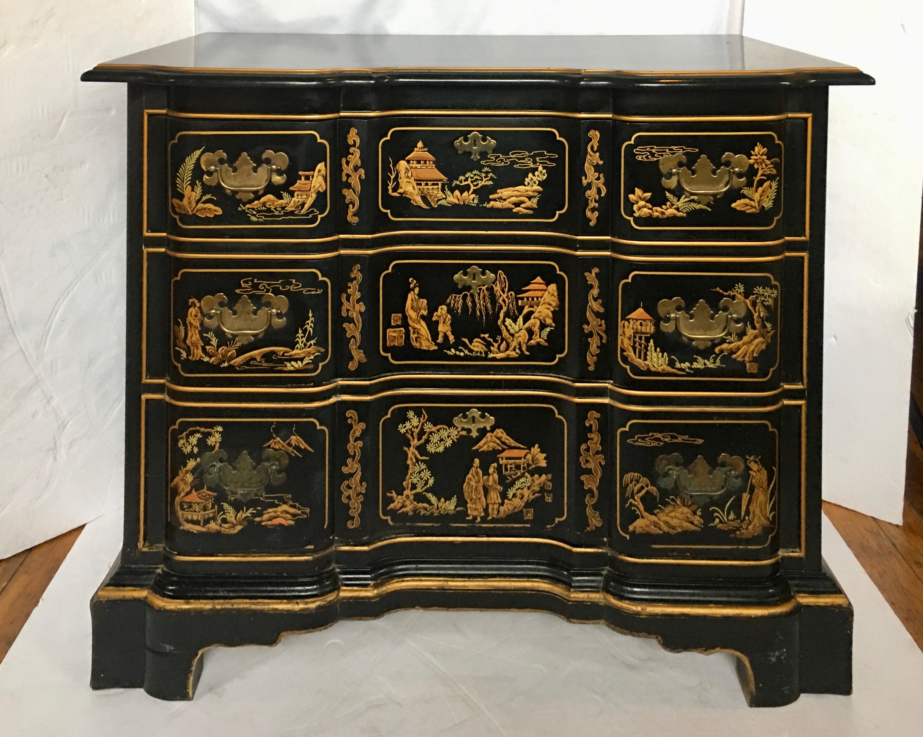 Chinoiserie style three-drawer chest and mirror set with black with gold painted accents by Drexel Et Cetera collection. Three dovetailed drawer fronts feature detailed painted scenes of figures, landscapes, pagodas, and architectural elements with