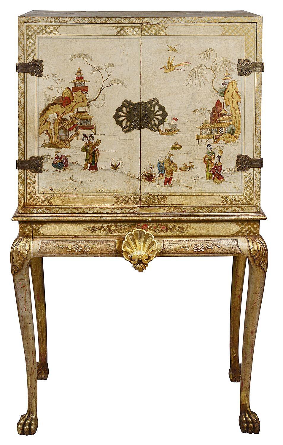 A very decorative early 20th Century cream coloured Chinoiserie lacquer cabinet on stand.Having classical scenes of courtiers and Geisha girls walking around the gardens of pagoda buildings by the lake side. Two doors opening to reveal shelves