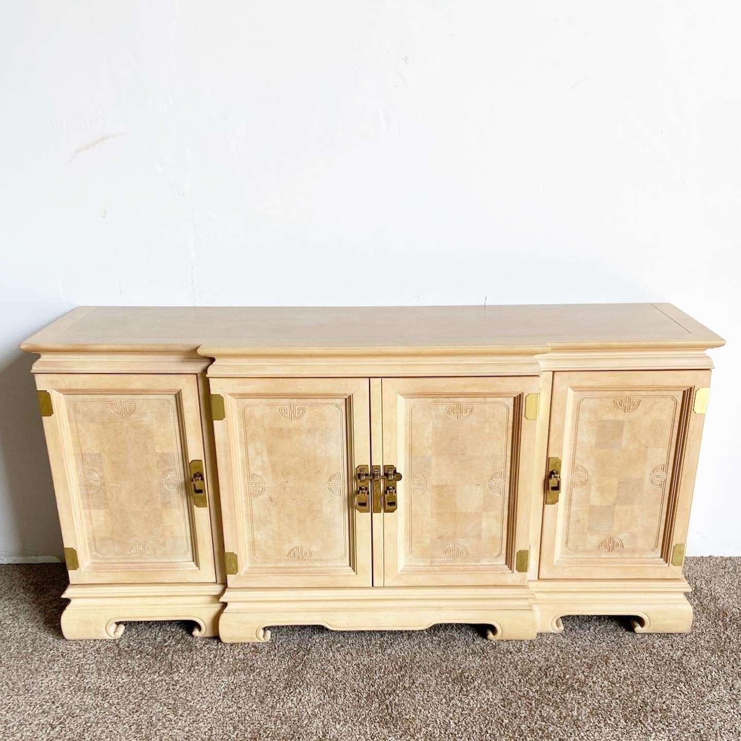Exceptional vintage chinoiserie Ming style credenza. Features a light brown finish with brass accents.

