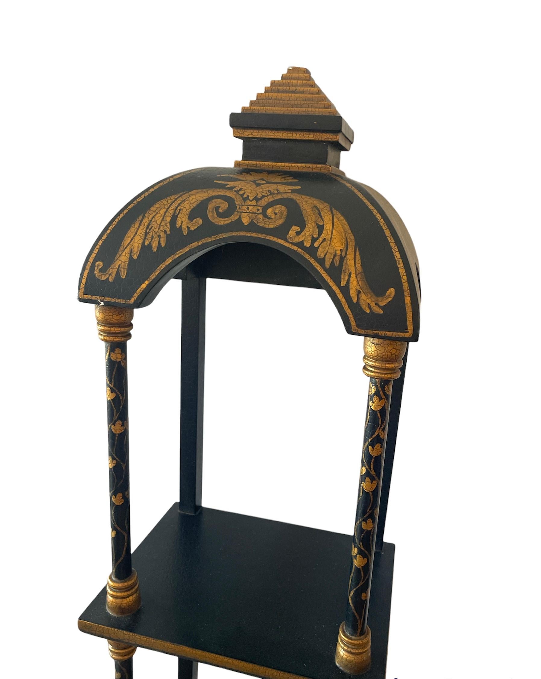Beautiful 3  wall shelf with Pagoda on top, painted crackled gold gilt on black crackled paint, the shelve themselves are actually smooth. very clean and unique item.
