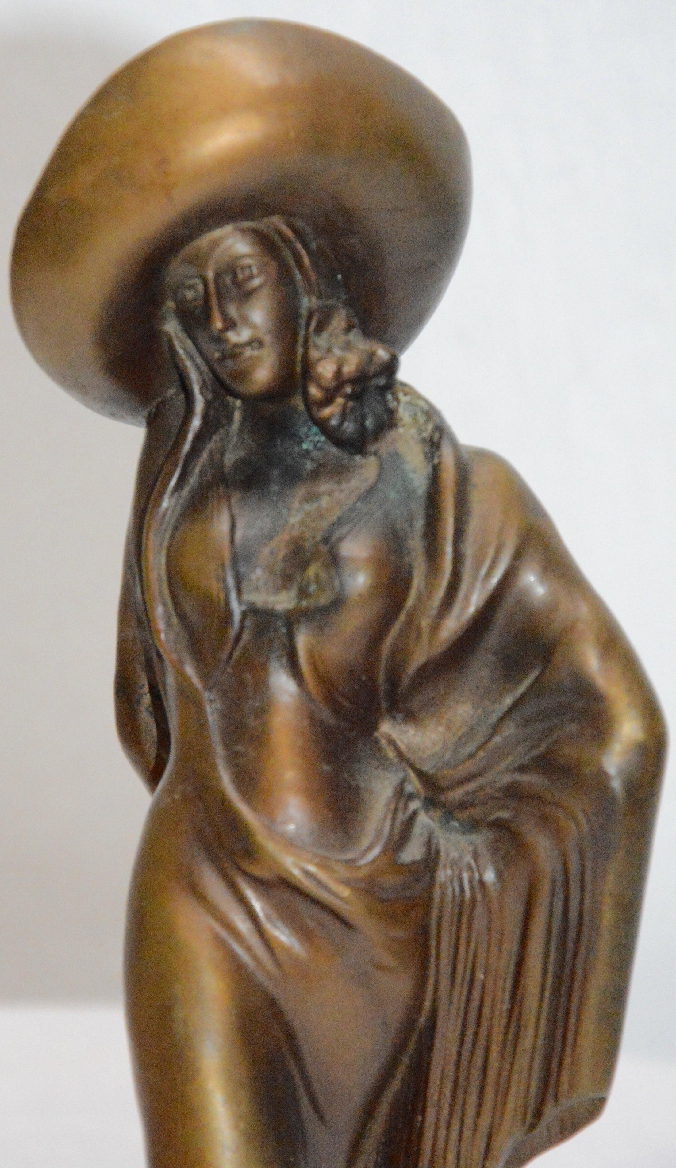 This is a stunning bronze statue by Demetre Chiparus, circa 1920s. The lady is showing her attitude with her twist. She is dressed in a long dress and her ensemble is topped off with a hat. She rest on a piece of marble.
 