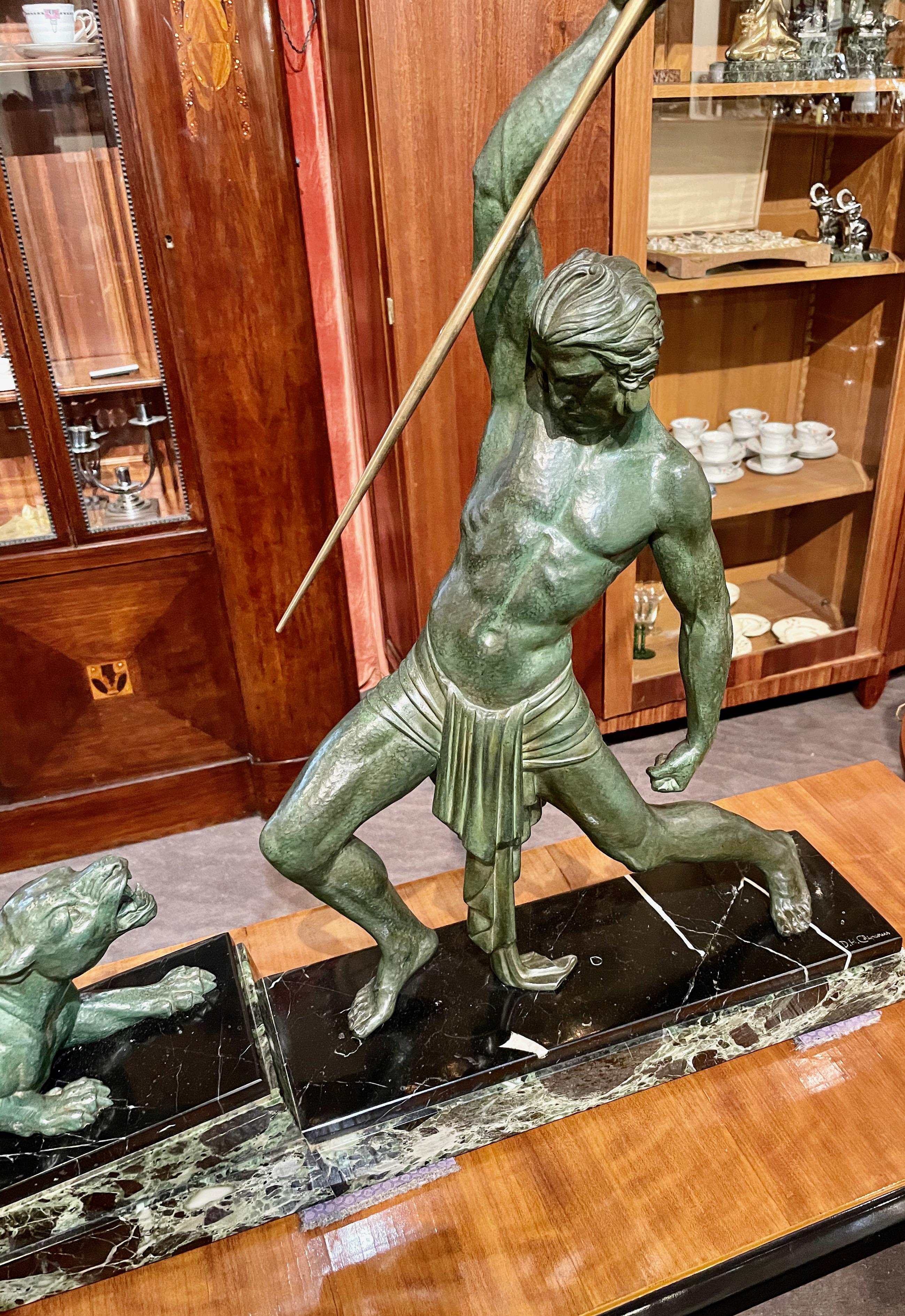 Large Art Deco sculpture of hunter and panther (or lion) by the famous sculptor Demetre H. Chiparus. The Art metal sculpture has a beautiful green verdigris patina and stands on an angled green/white/black multi-color marble base. Excellent