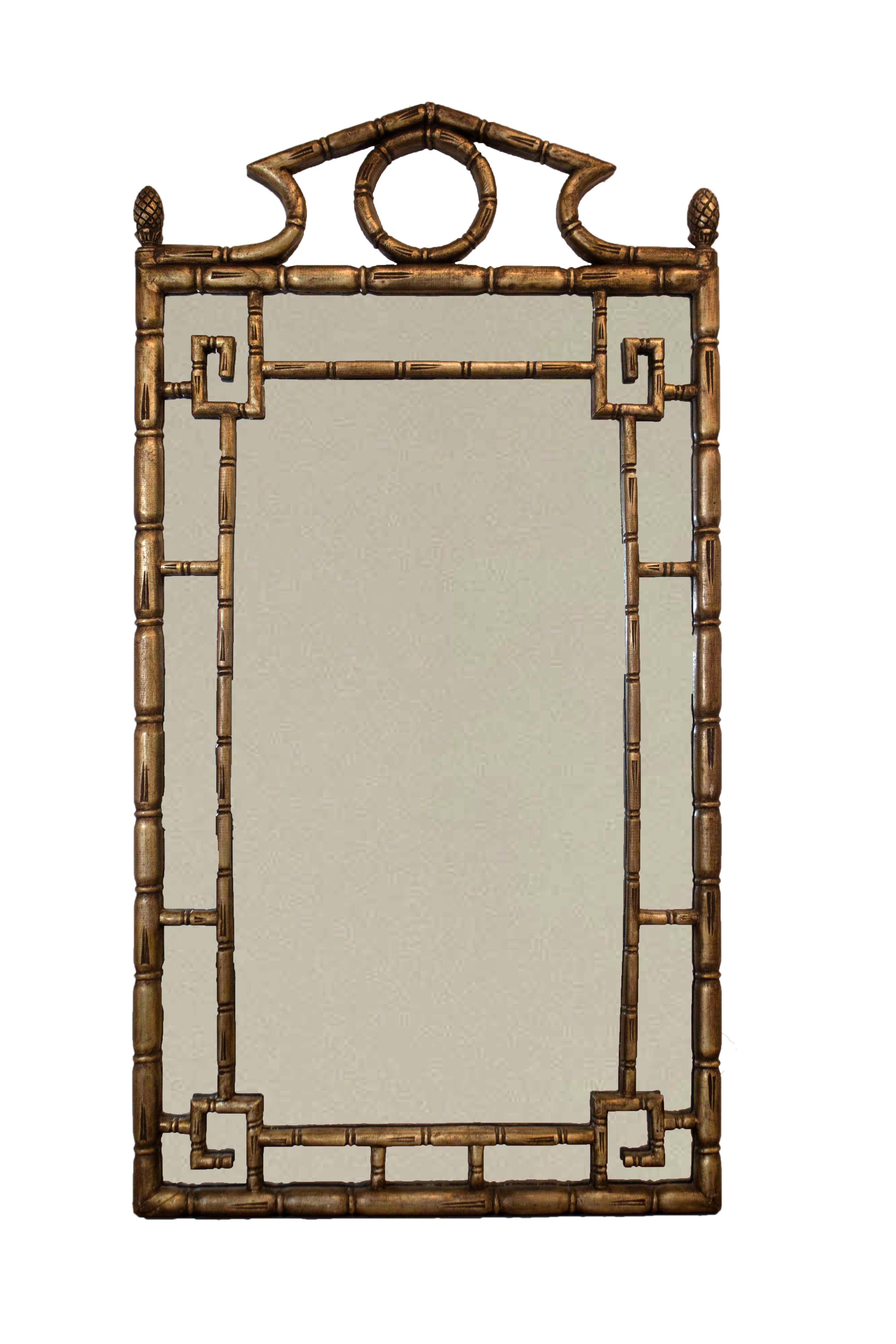 This Chippendale, Hollywood Regency mirror is detailed in gold, faux bamboo and a Chinoiserie style frame. In very good vintage condition.

Dimensions: 26W x 49H x 1.75D.