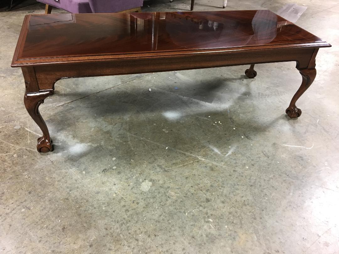 This is a made-to-order Chippendale Ball and Claw traditional mahogany coffee table made in the Leighton Hall shop. It features a field crotch mahogany with a solid mahogany ogee shaped edge It has a hand rubbed and polished semigloss finish. The