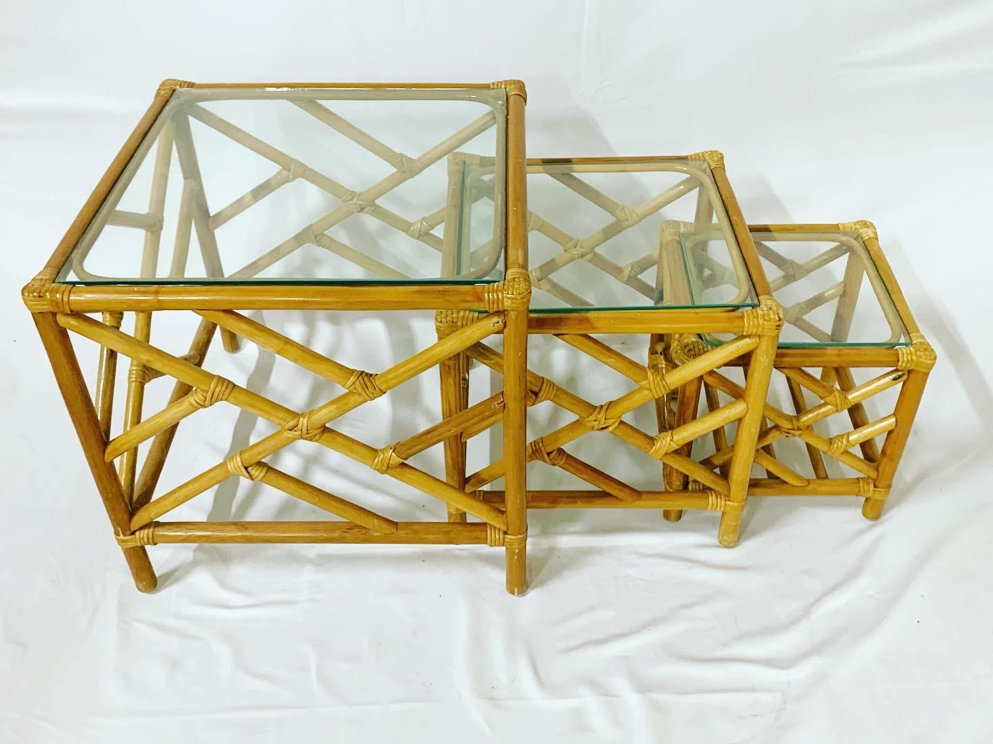 Bamboo rattan nesting tables with Chinese chippendale design and glass tops. These are three tables in total which nest perfect within each other.
Largest table measures: 22”x22” with a height of 21”
Middle table: 17”x17” with a height of