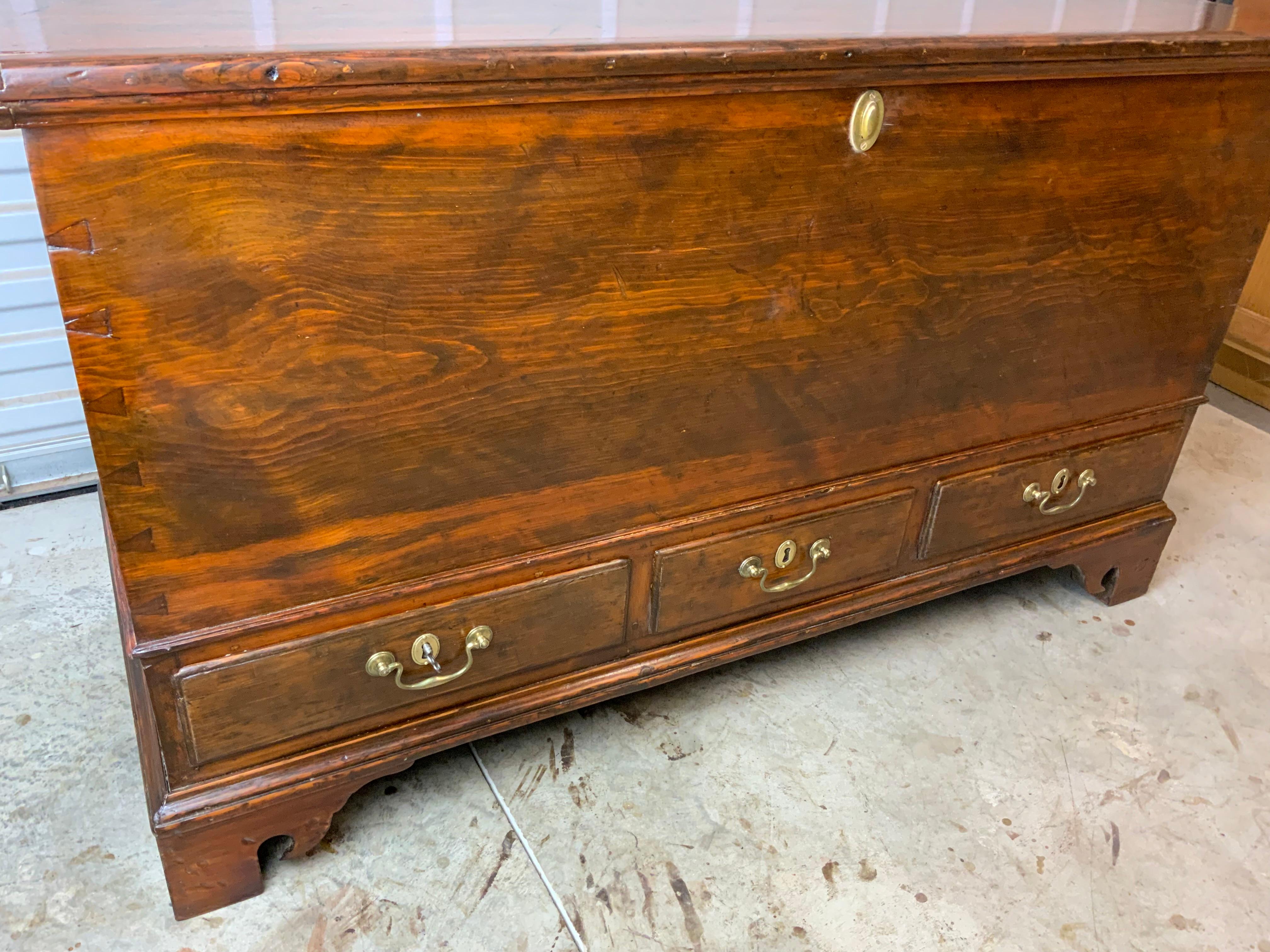 A great example of a large Pine six board 18th century Chippendale blanket chest. This piece has an excellent color and patina on an older refinish and has been cleaned and waxed.  Drawer hardware is original to the piece and all the locks are
