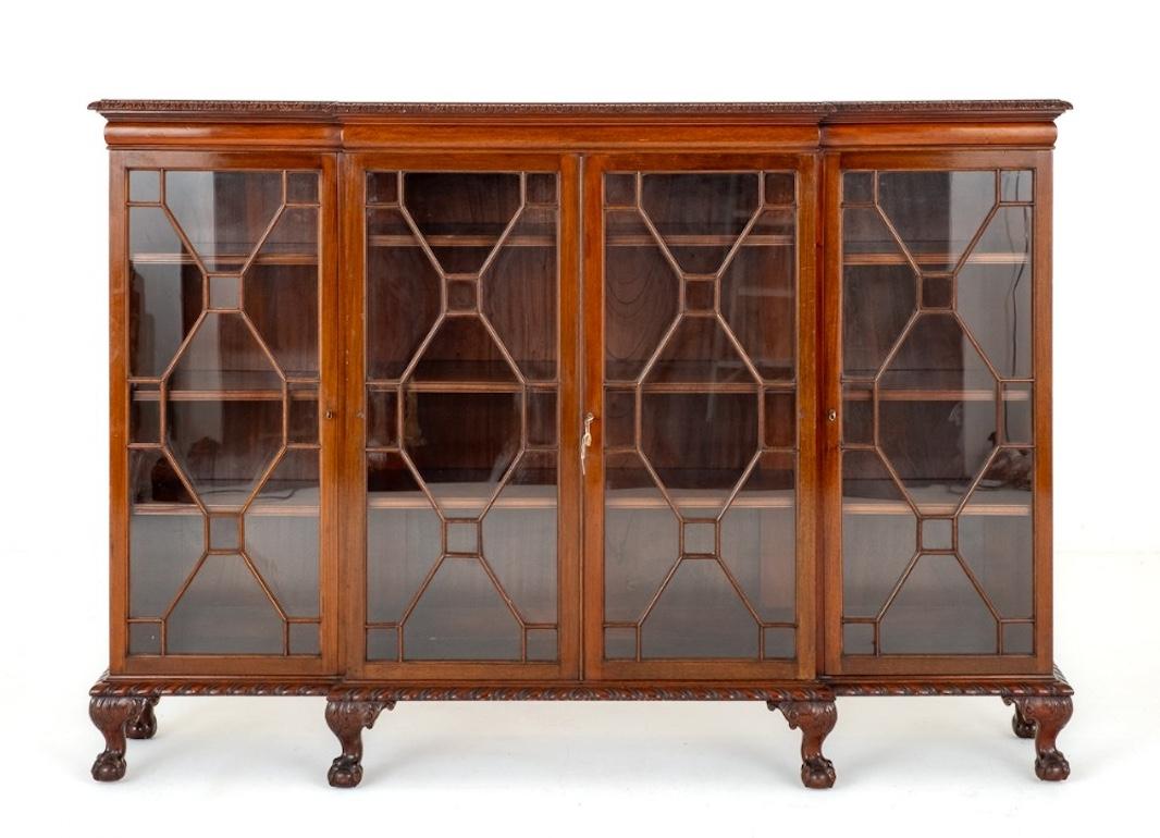 Impressive mahogany Chippendale style 4 door breakfront bookcase. Circa 1900
This quality 4 door bookcase stands upon a squat cabriole legs with boldly carved ball and claw feet. The astragal glazed doors open to reveal adjustable shelving. The
