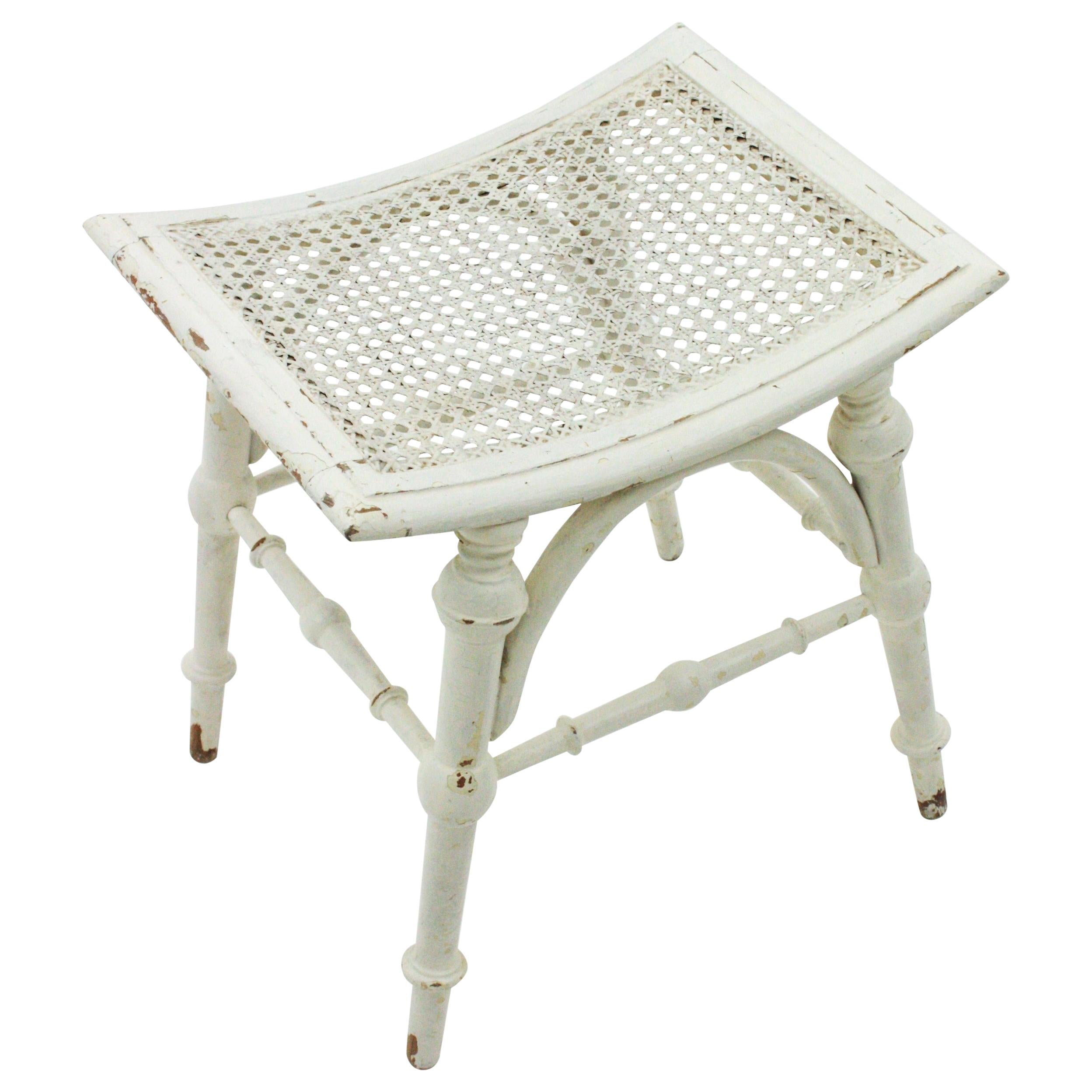 Lovely wooden Chippendale stool or side table with woven wicker top, 1920s-1930s.
Tuned wood structure with four legs and stretchers joining them. It has a terrific aged patina in white color. The cane seat is in good condition.
This stool can be