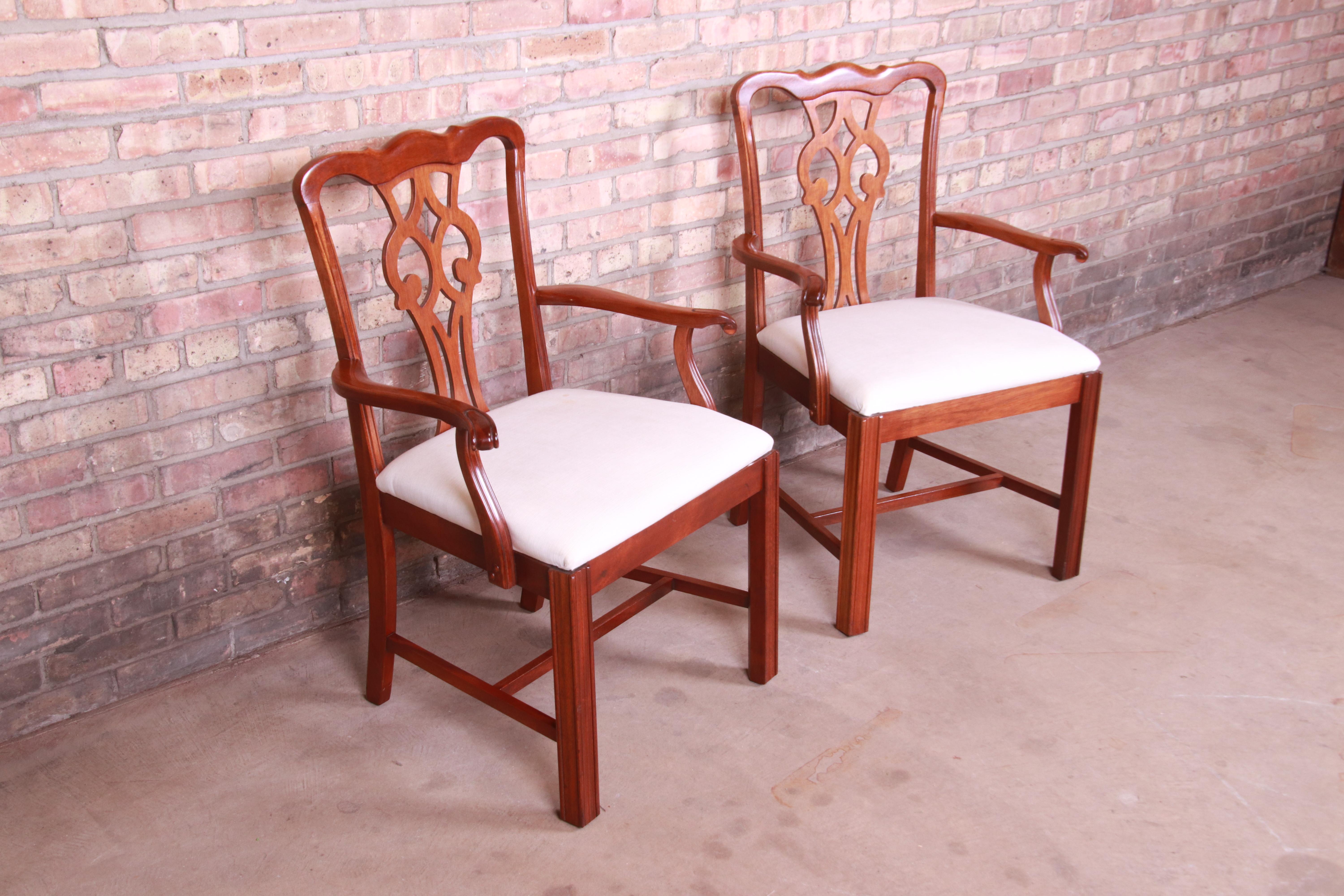 A gorgeous pair of club chairs or dining armchairs

By Ephraim Marsh

USA, mid-20th century

Solid mahogany frames with ivory upholstered seats.

Measures: 26