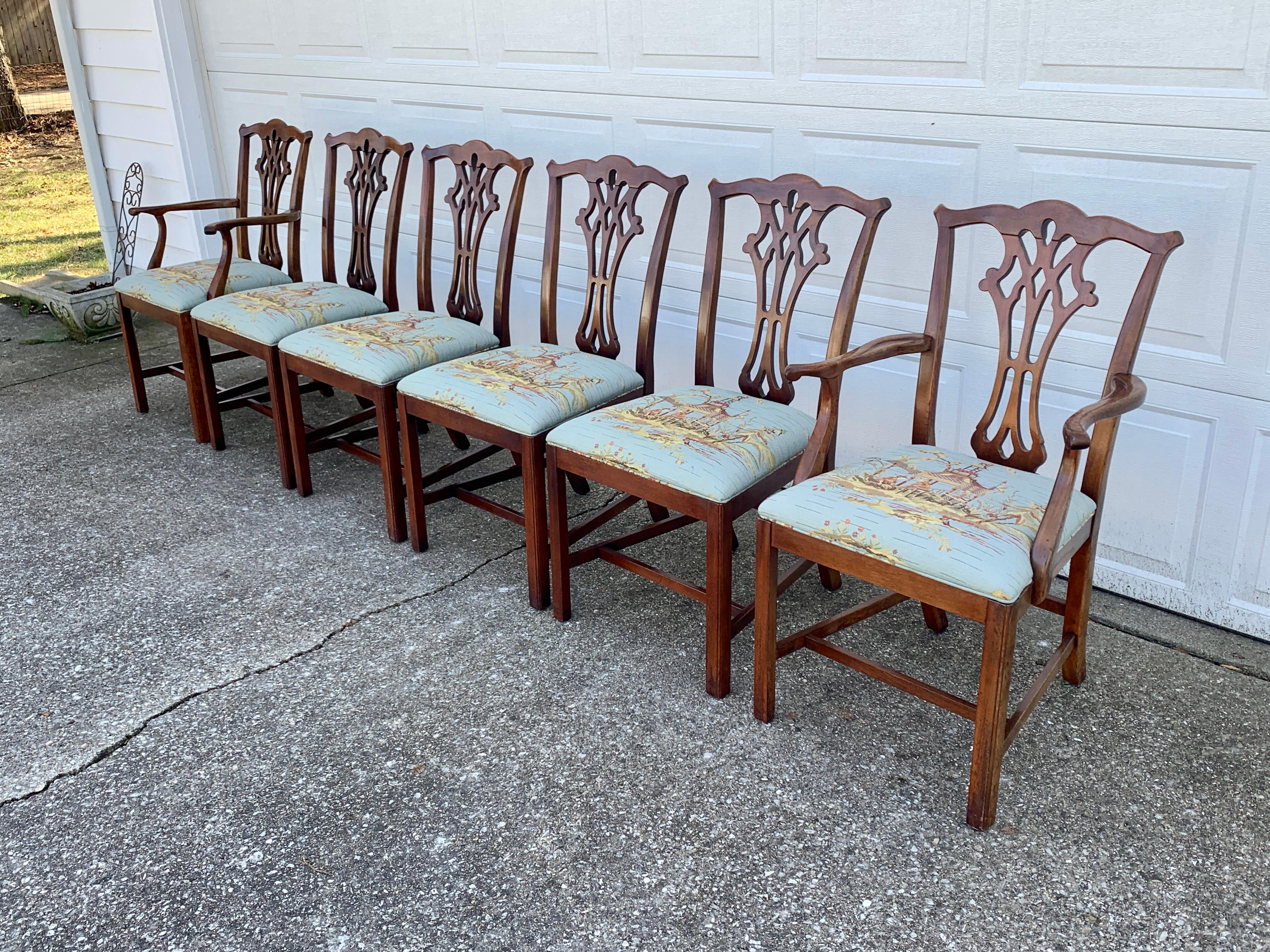 A gorgeous set of six Chippendale style dining chairs

In the manner of Baker Furniture

USA, Late 20th Century

Carved solid mahogany frames with chinoiserie patterned upholstered seats.

Measures:
Side chairs - 20.5