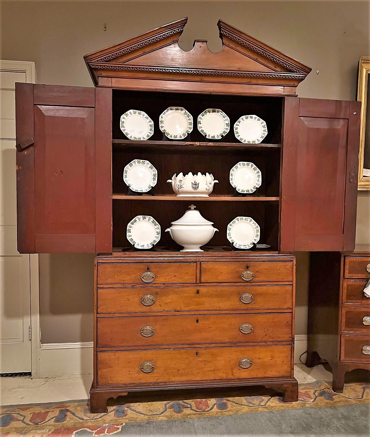 This handsome cupboard probably started life in the late 18th Century as a 2-over-3-drawer Chippendale old-growth cherry wood chest.  In the early 19th Century a 2-door cabinet was adapted to fit on top of the chest. Sometime in the early 20th