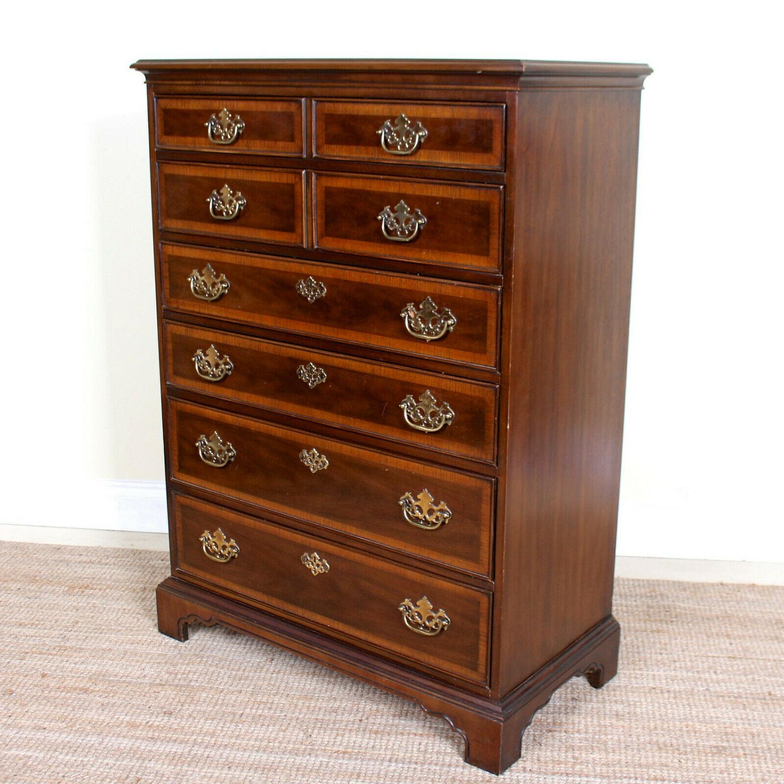 An impressive tallboy chest of drawers in the Chippendale manner by Drexel.

The marquetry inlay adorned drawers mounted with good handles, dovetailed jointing and solid clean interiors. Chamfered edged and raised in a cutaway plinth base