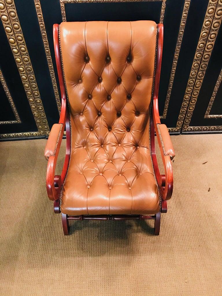 Beautiful Chesterfield leather armchair in brown. 
Good condition, normal signs of wear due to age. The frame is made of mahogany wood.