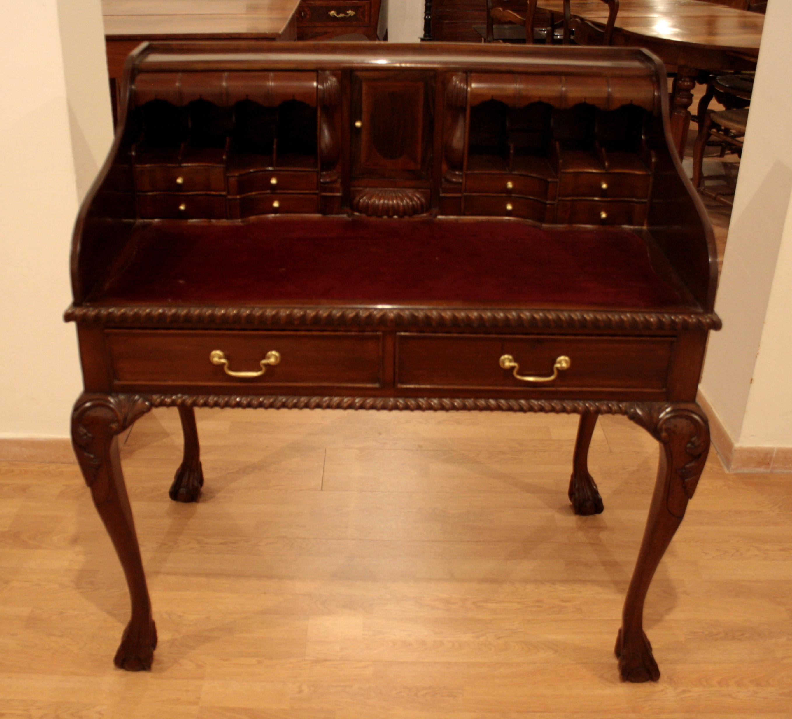 Chippendale writing desk

Writing desk, with arched legs and delicate carvings. It has 2 large drawers, 8 drawers and 7 small 'secret' drawers. The writing surface in red velvet enhances the style and comfort of this aristocratic and compact desk,