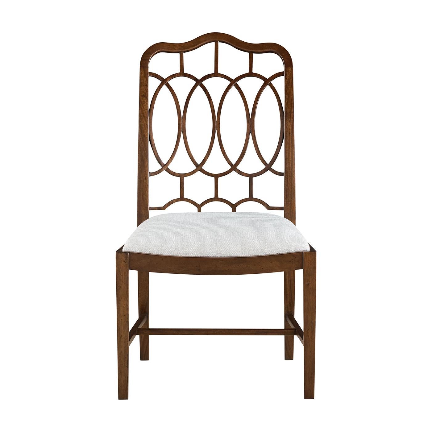 Paying tribute to 18th-century English design with a fresh sense of proportion and purpose. Its iconic back features an interlocking oval and lattice pattern—classic elements drawn from Thomas Chippendale's legendary style—while a gently curved