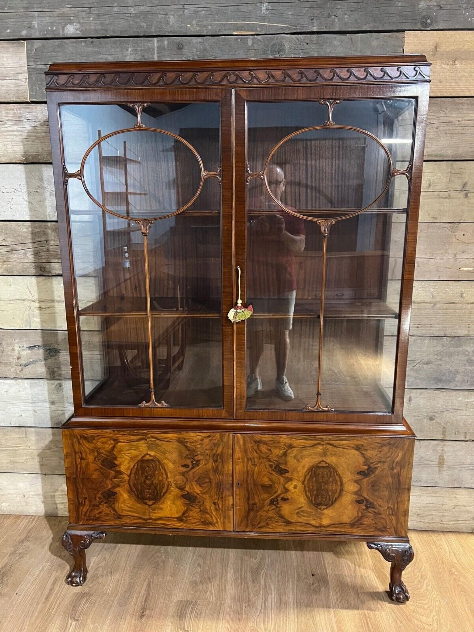 Antique bookcase / display cabinet in the Chippendale manner
Features distinctive ball and claw feet
Crafted from mahogany and walnut and circa 1900
Great patina to the walnut on this clean piece of antique furniture
Offered in great shape ready for