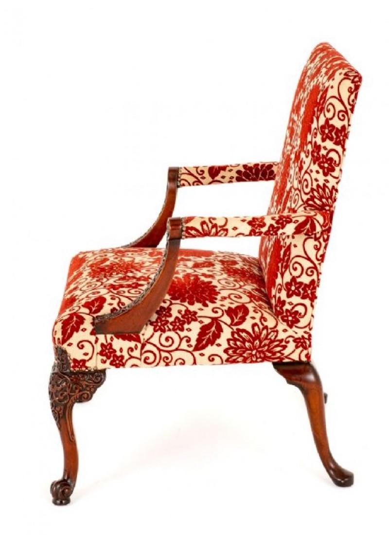 Chippendale Style Mahogany Gainsborough Chair.
Circa 1920
This Chair Stands Upon Carved Cabriole Front Legs With French Style Carved Toes and Shaped Back Legs.
The Arm Supports also being of a Carved Form.
The Chair is of a Generous Size and is
