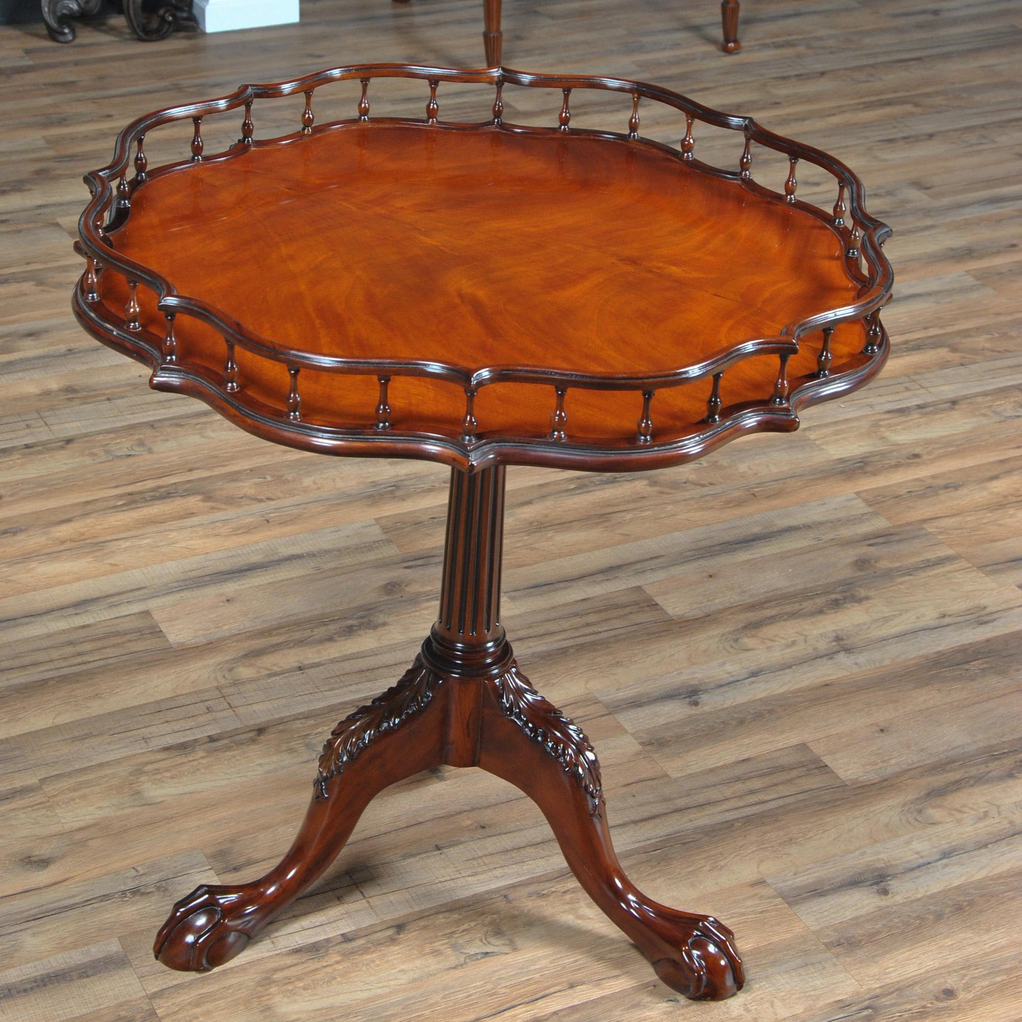 A fantastic round table which we refer to as the Chippendale Gallery Table. Hand turned, solid mahogany pillars support the gallery around the top of the item while a solid mahogany, hand carved and reeded column supports the top itself. All of the